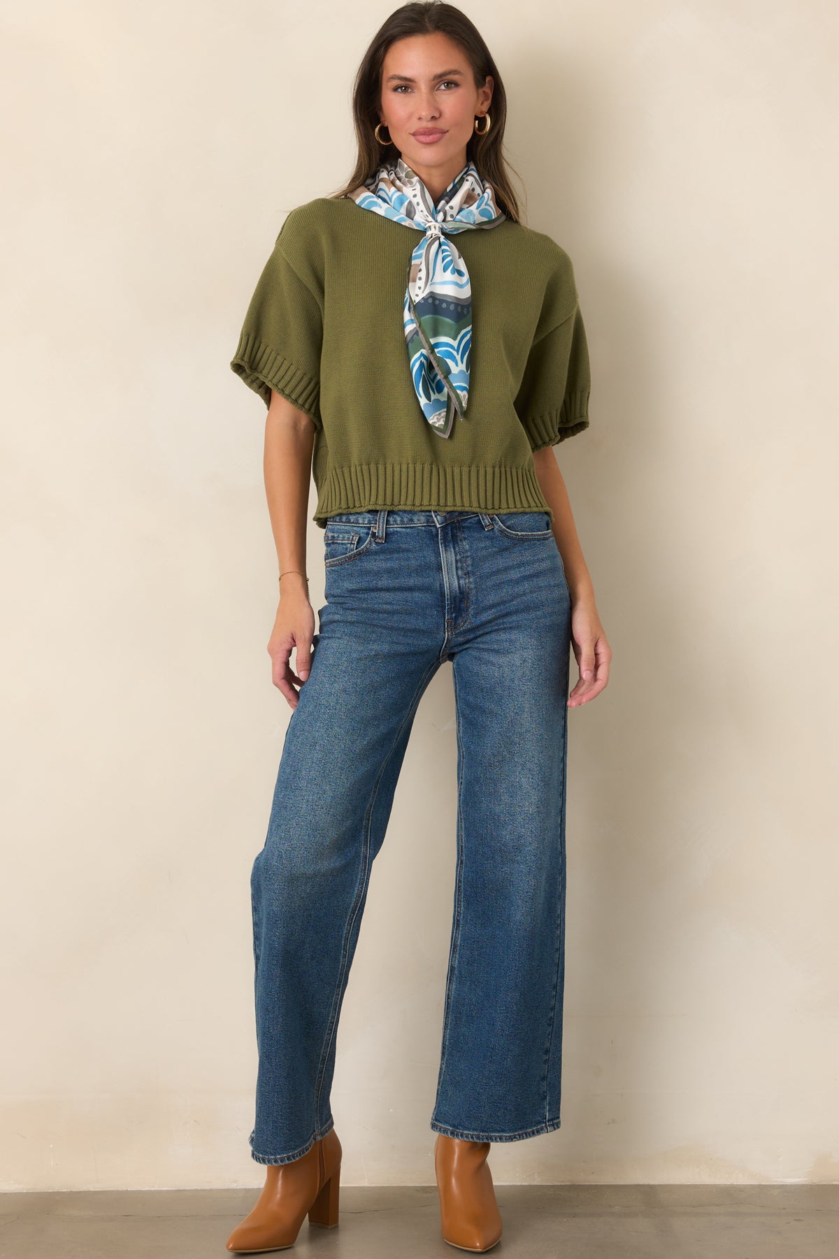 Medium wash jeans with a high-rise waist and relaxed straight leg silhouette.
