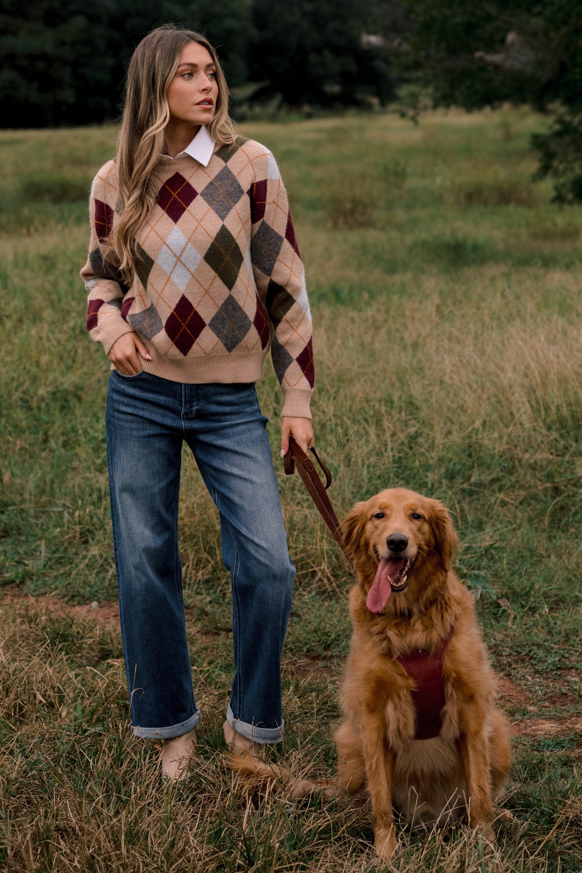 Medium wash jeans with a flattering high-rise waist, relaxed straight-leg silhouette, and neatly cuffed hems.