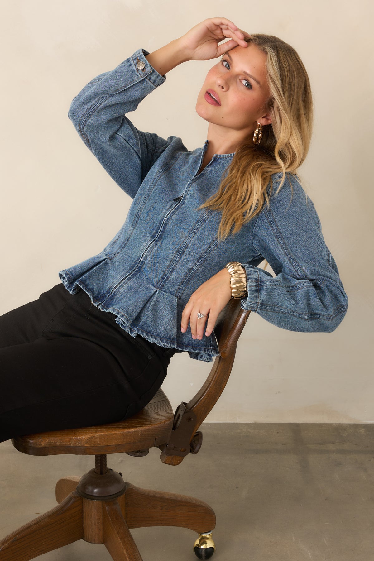 Medium wash jacket highlighting the collarless neckline and front zipper.