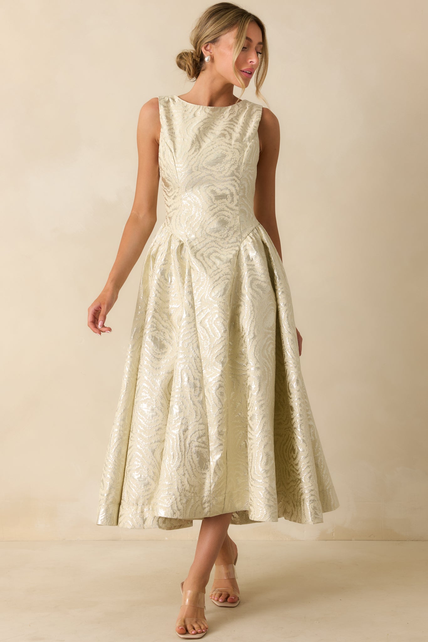 Metallic jacquard midi dress in ivory highlighting the subtle sheen and full, pleated design.