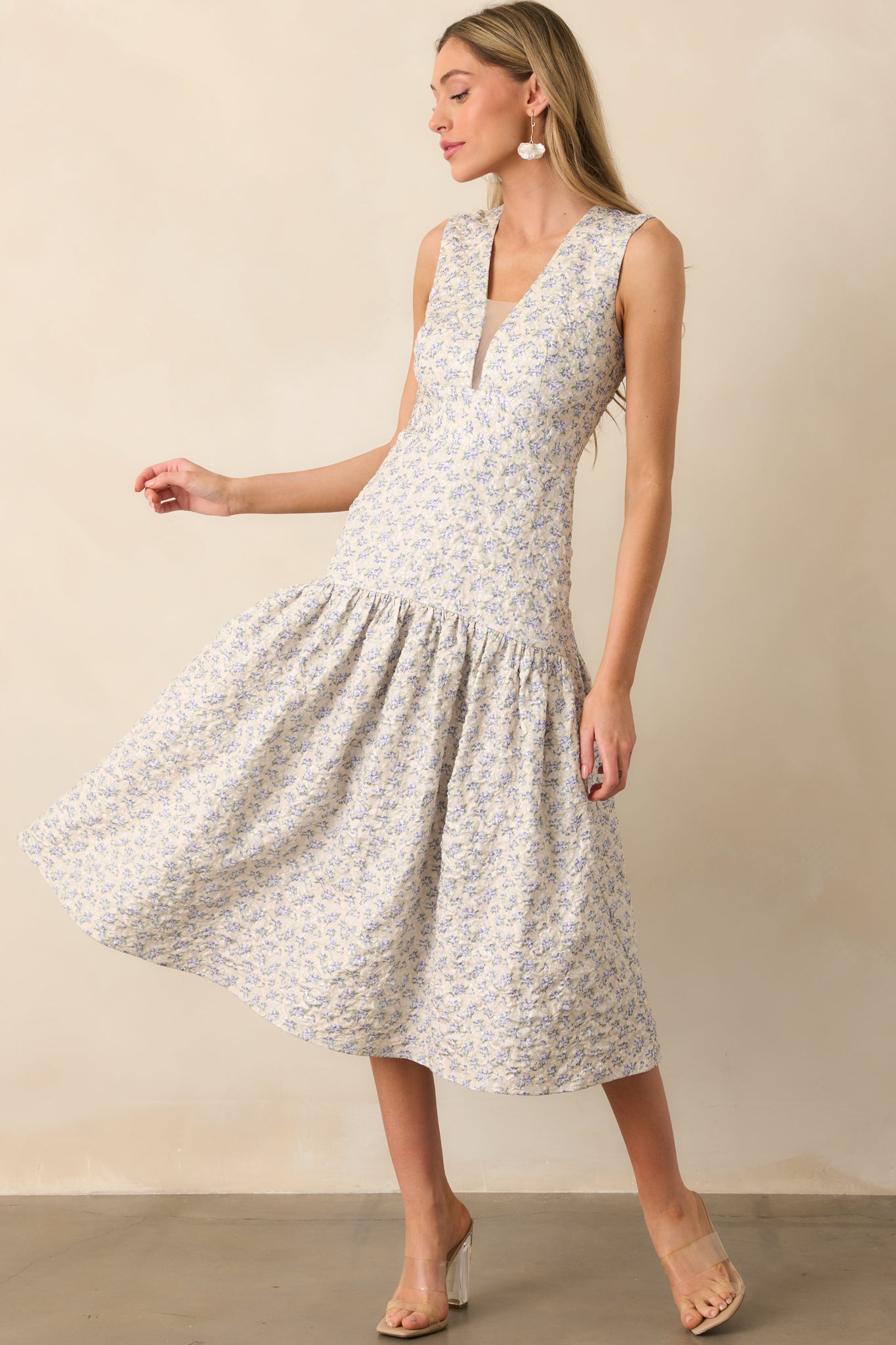 Periwinkle midi dress displayed in a full view, emphasizing the fitted bodice and flow of the drop waist skirt.