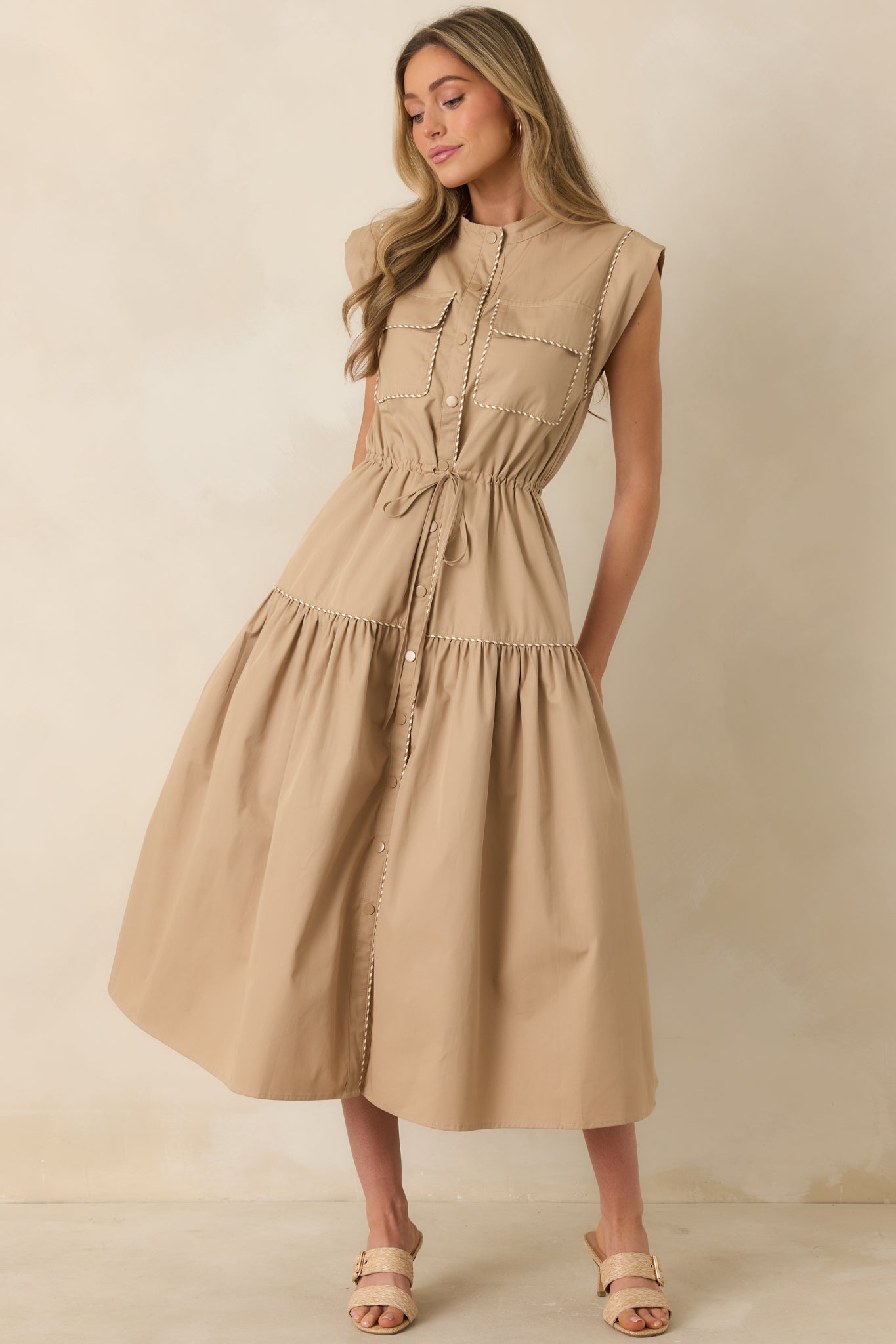 Midi dress featuring drawstring waist, stand collar, cap sleeves, and utility pockets