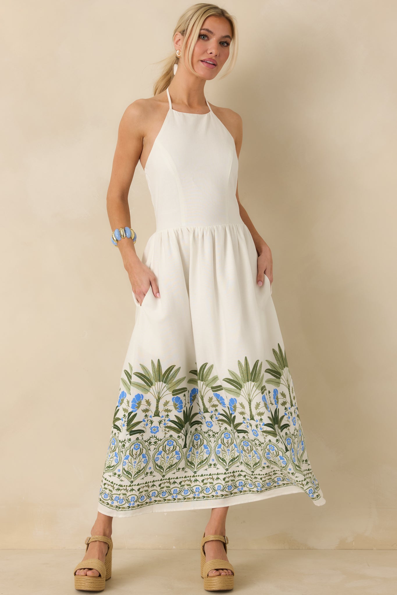 Midi dress in ivory featuring softly gathered skirt and breezy silhouette.