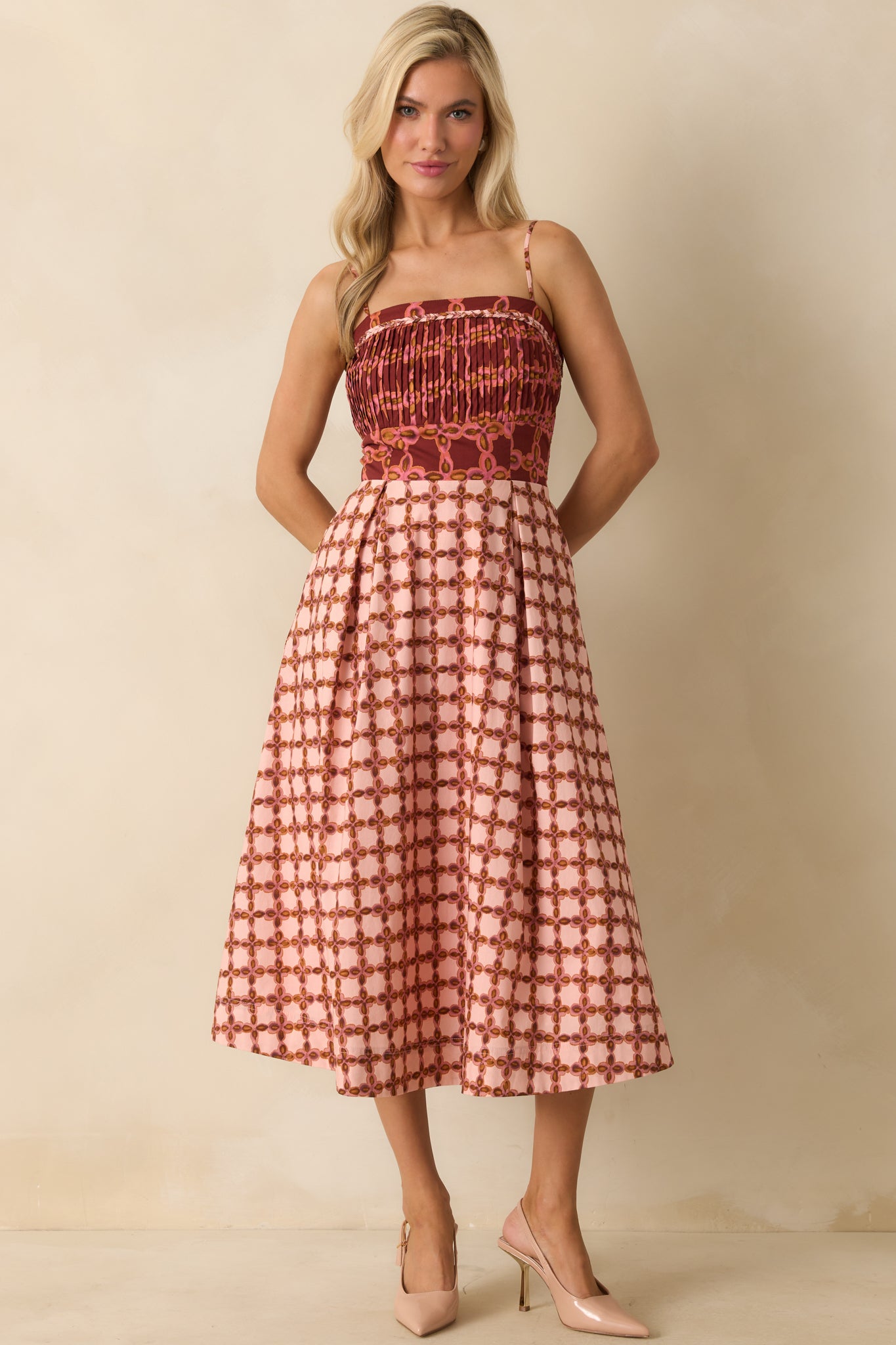 Fitted top midi dress showcasing the colorful geometric print and relaxed skirt silhouette.