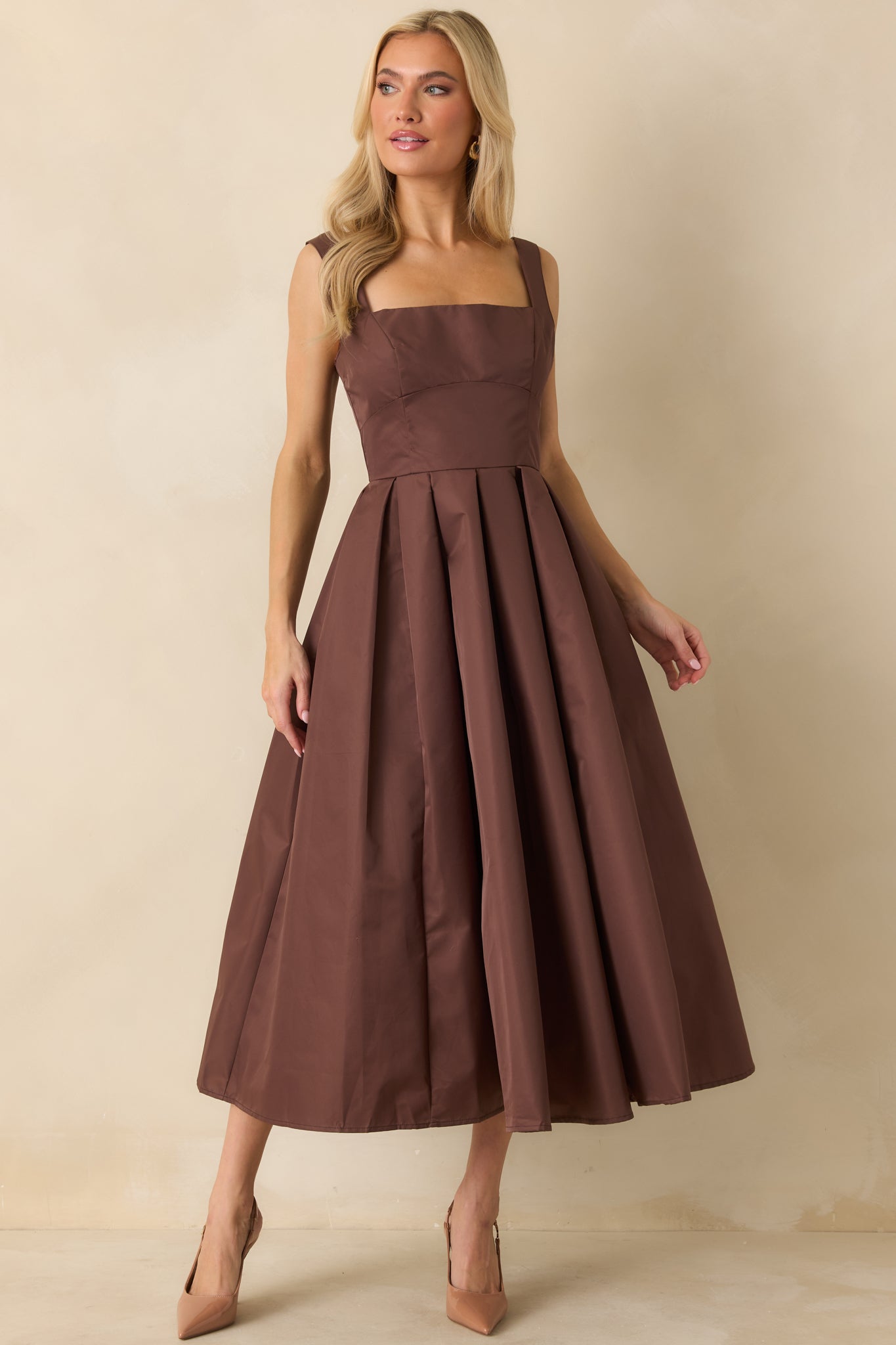 Midi dress displaying clean lines, square neckline, and voluminous skirt.