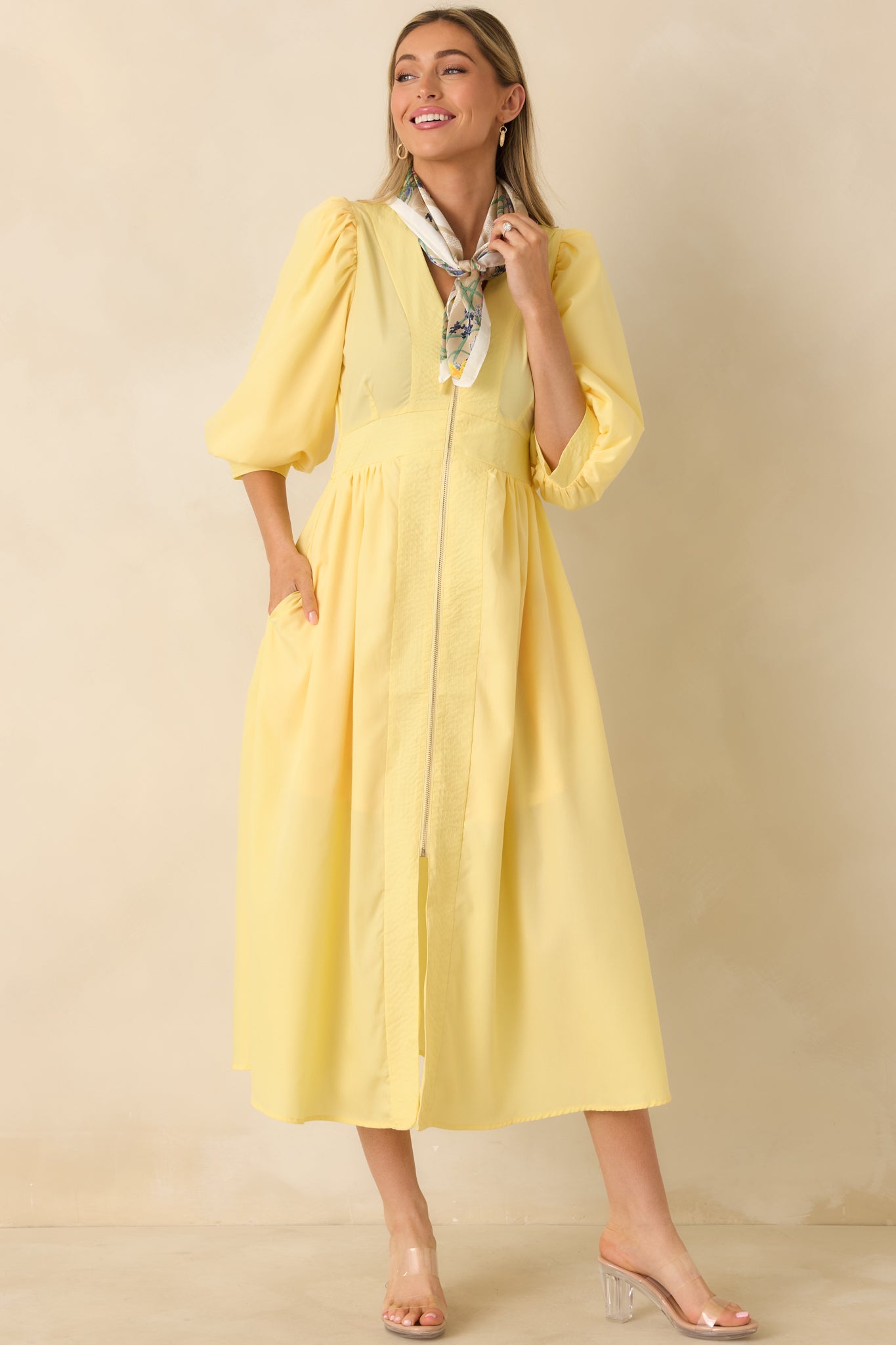 Yellow woven midi dress with blouson sleeves, structured waistband, and an exposed zipper for a streamlined front silhouette.