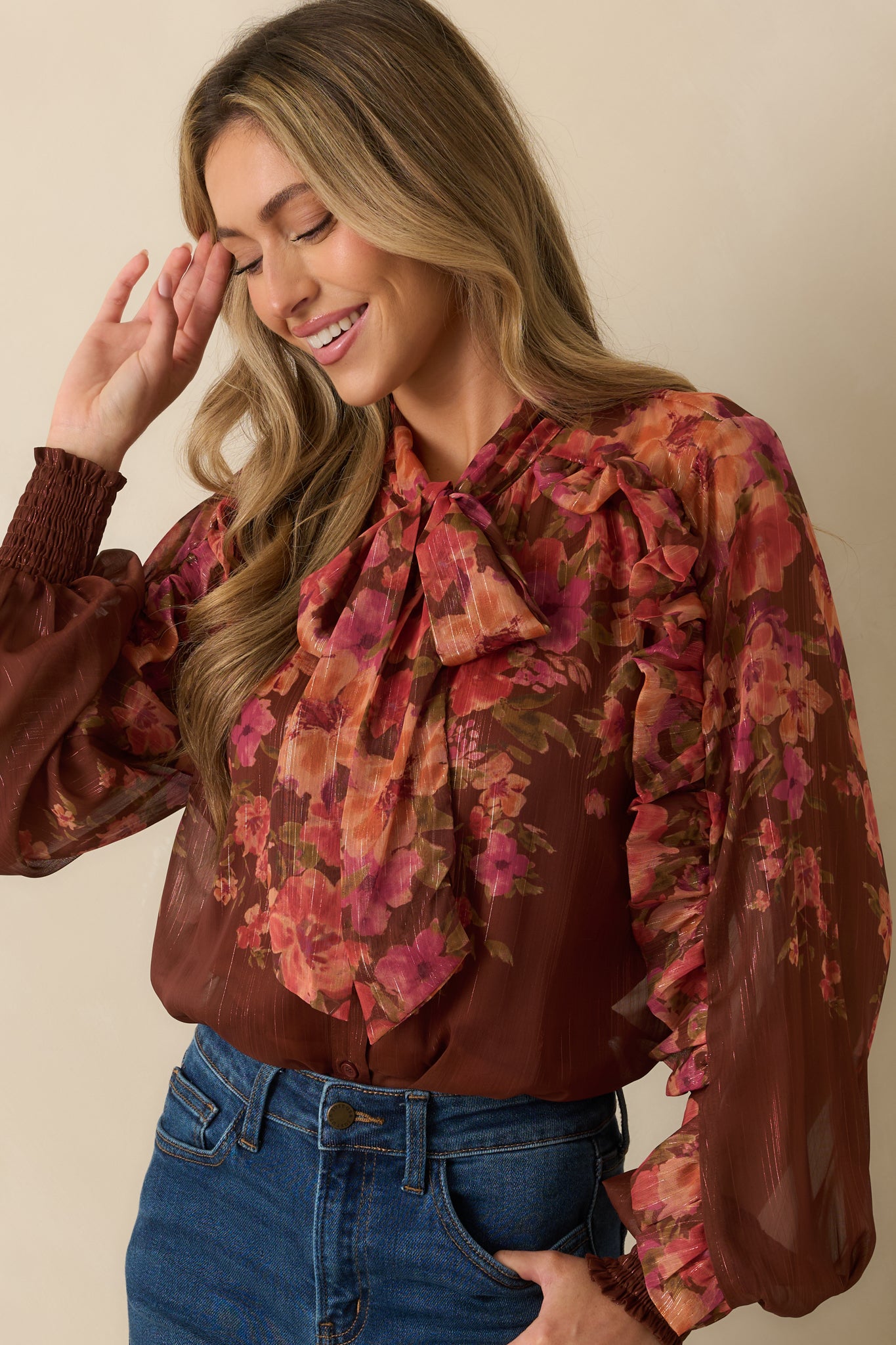 Midsection close-up highlighting smocked cuffs, lightweight sheer fabric, and floral print.