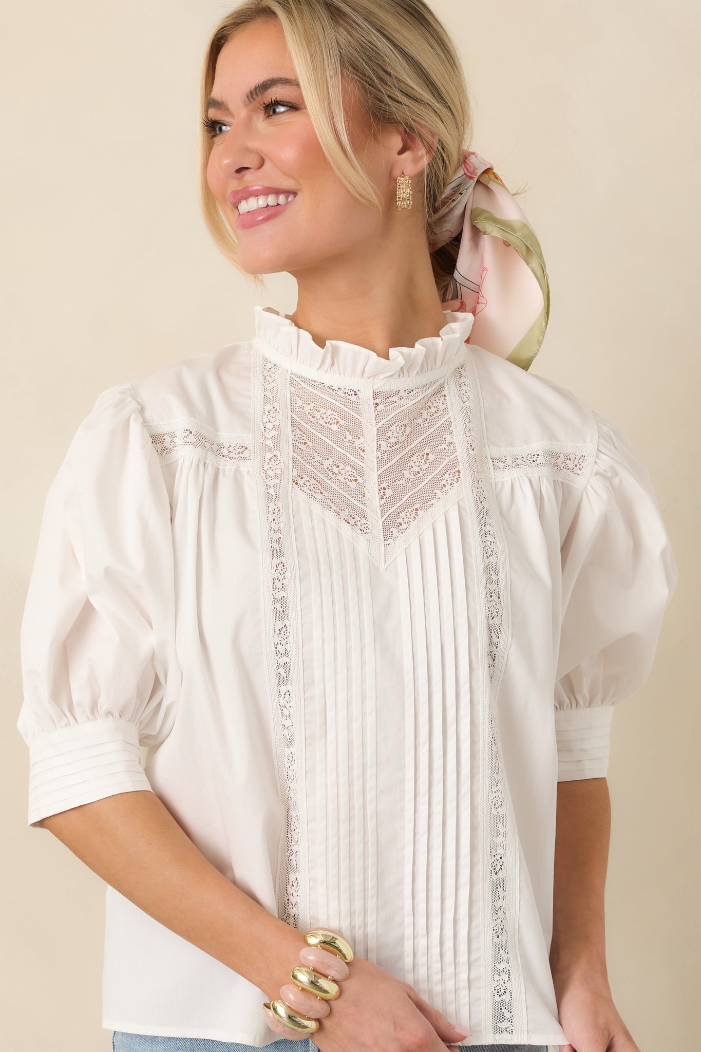 Midsection crop highlighting the puff sleeve cuffs and the relaxed fit of the blouse.