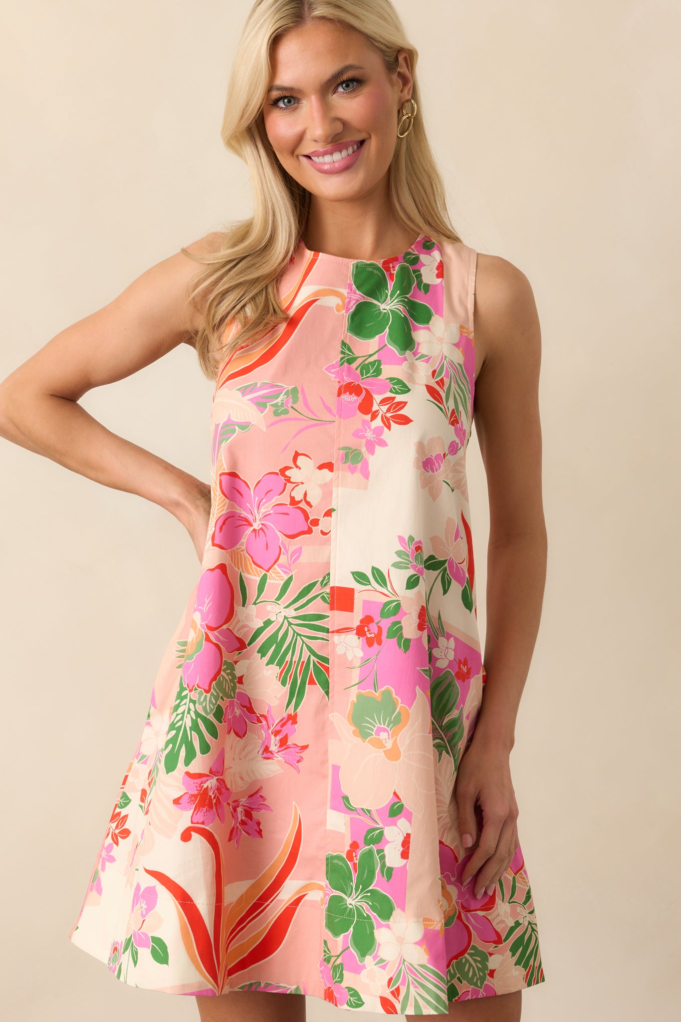 Midsection crop focusing on the waist and pocket area, with colorful floral details on the pink fabric.