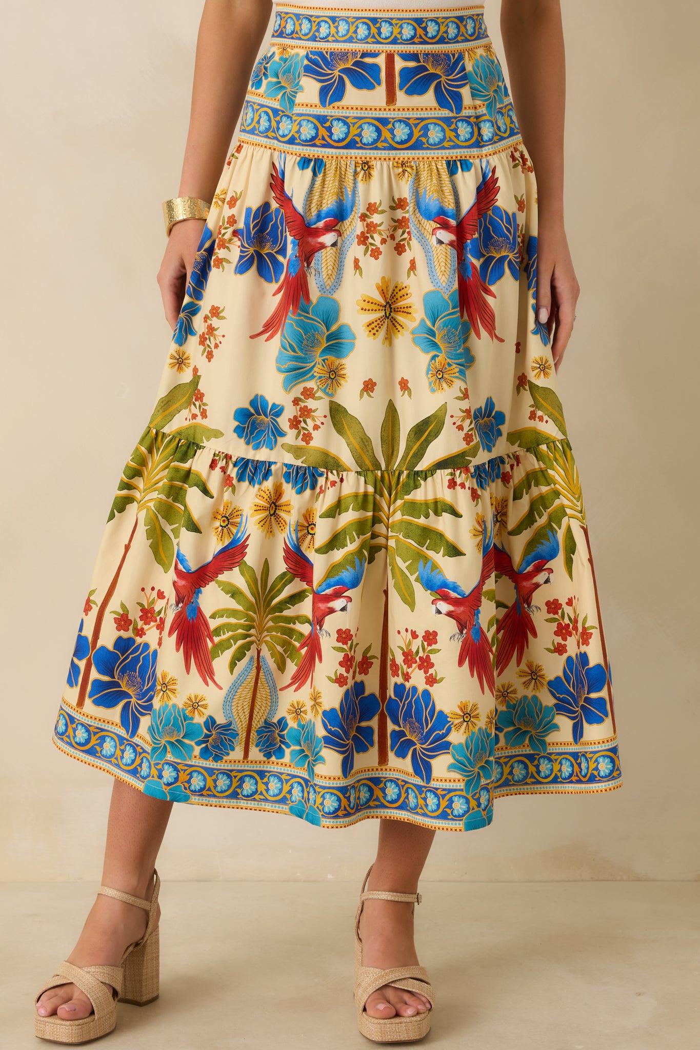 Midsection crop showing high-rise waistband and top tier of flowing multicolored skirt.