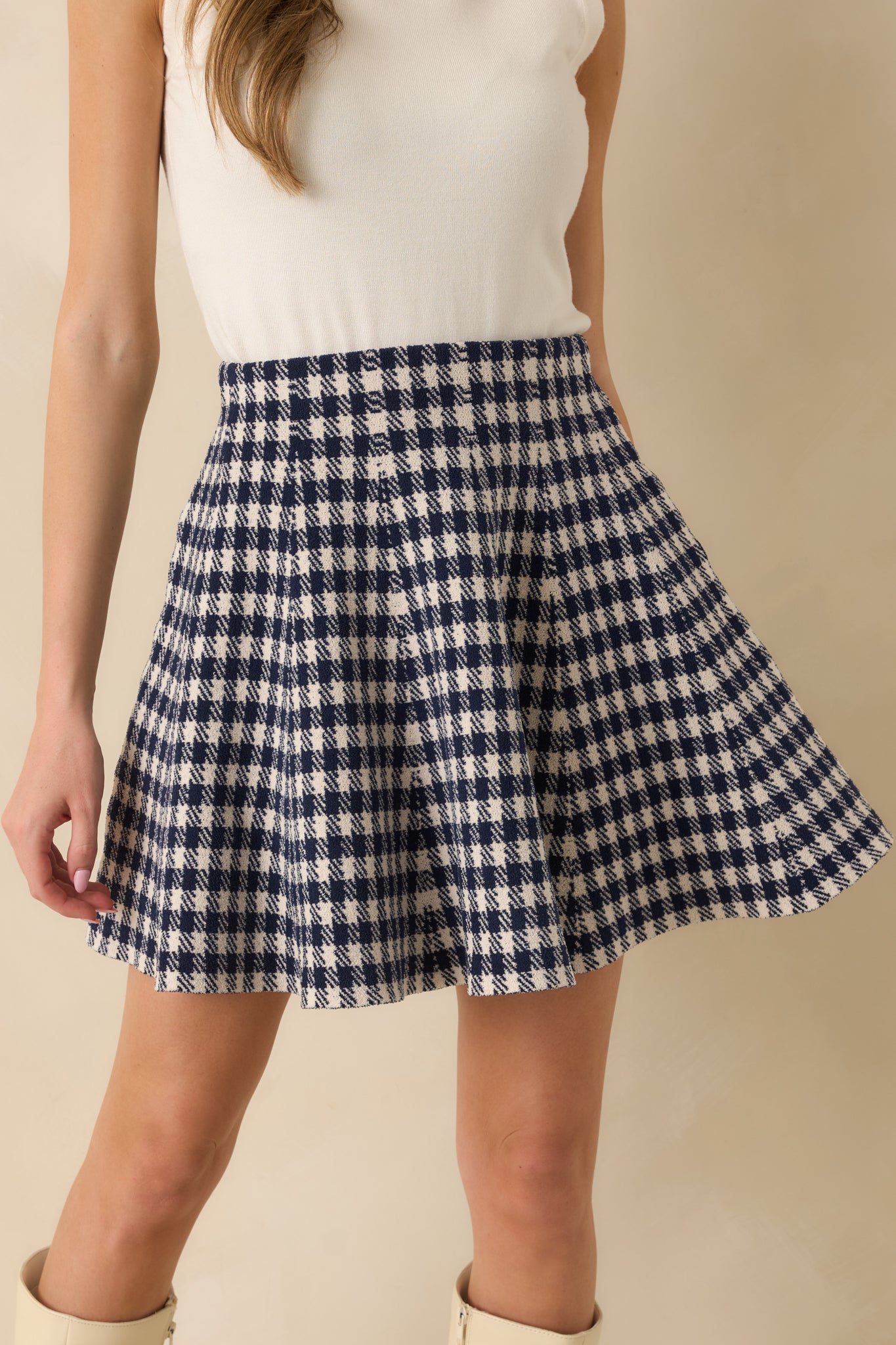 Midsection crop showing soft stretch knit fabric and subtle gingham pattern.