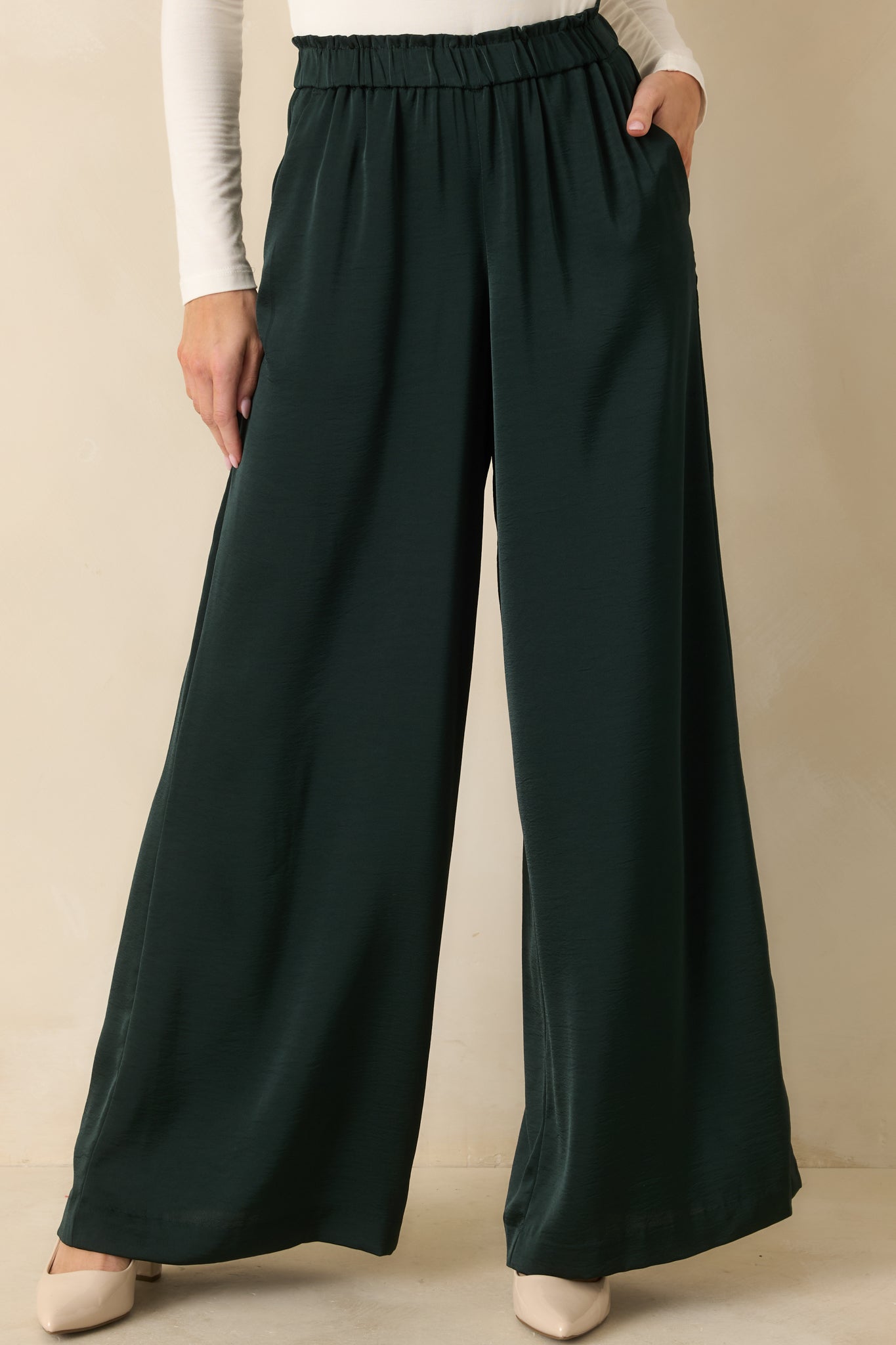 Midsection crop showing the elastic waistband and smooth front fabric of the pants.