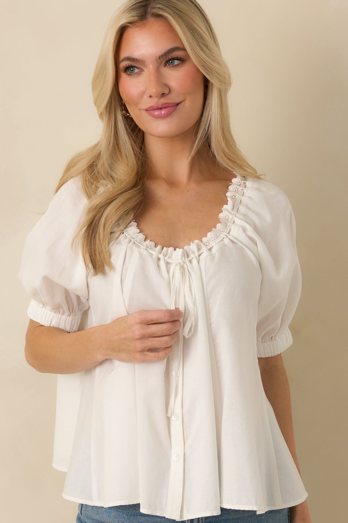 Midsection view showing full button-front closure and relaxed blouse silhouette.