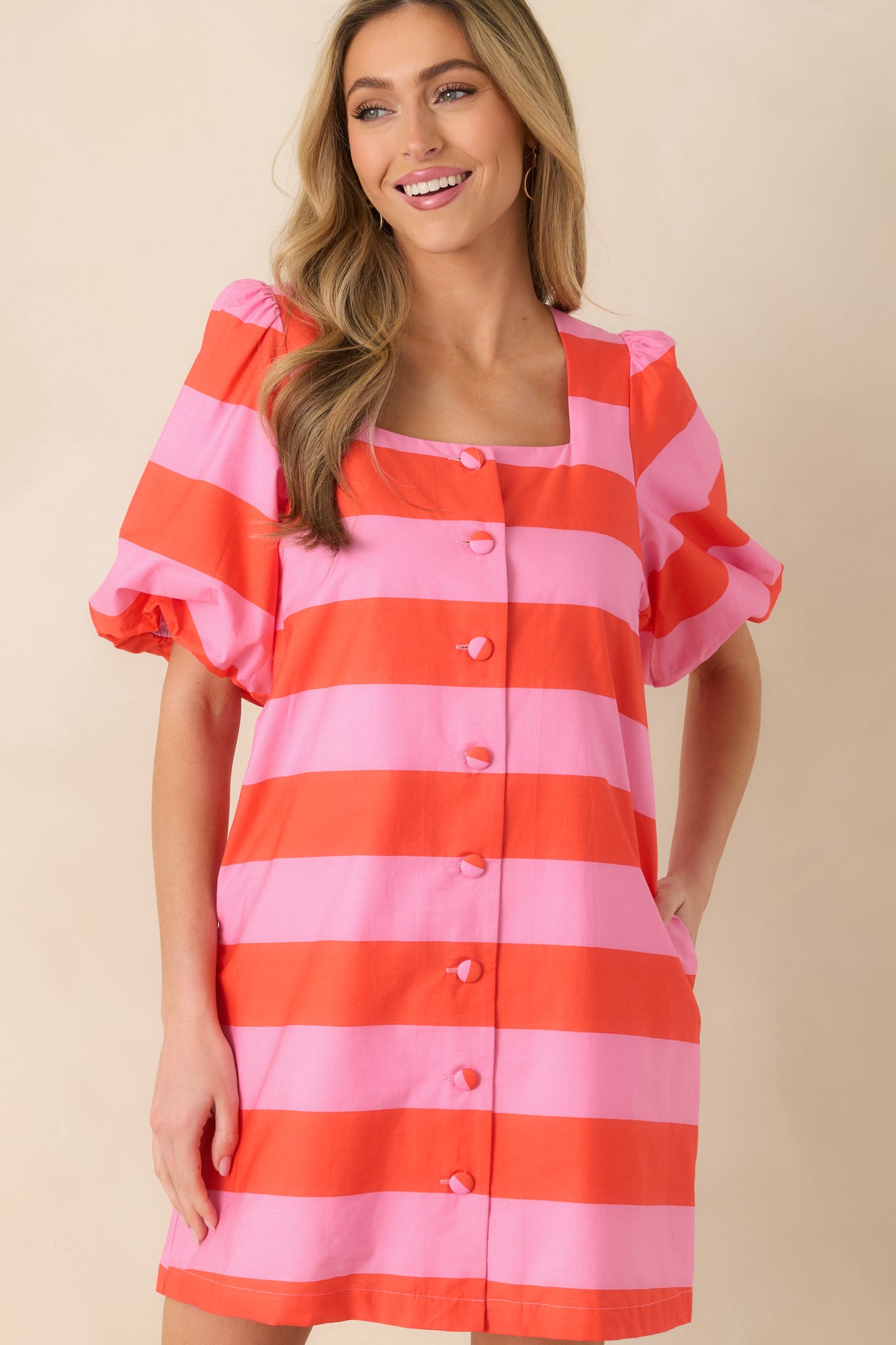 Midsection of the mini dress emphasizing the alignment of the bright stripe design.