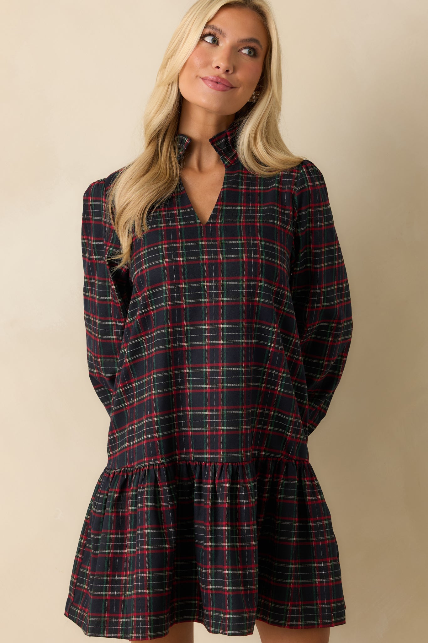 Detail of front of mini dress, emphasizing plaid pattern, standing collar, and soft woven flannel fabric.