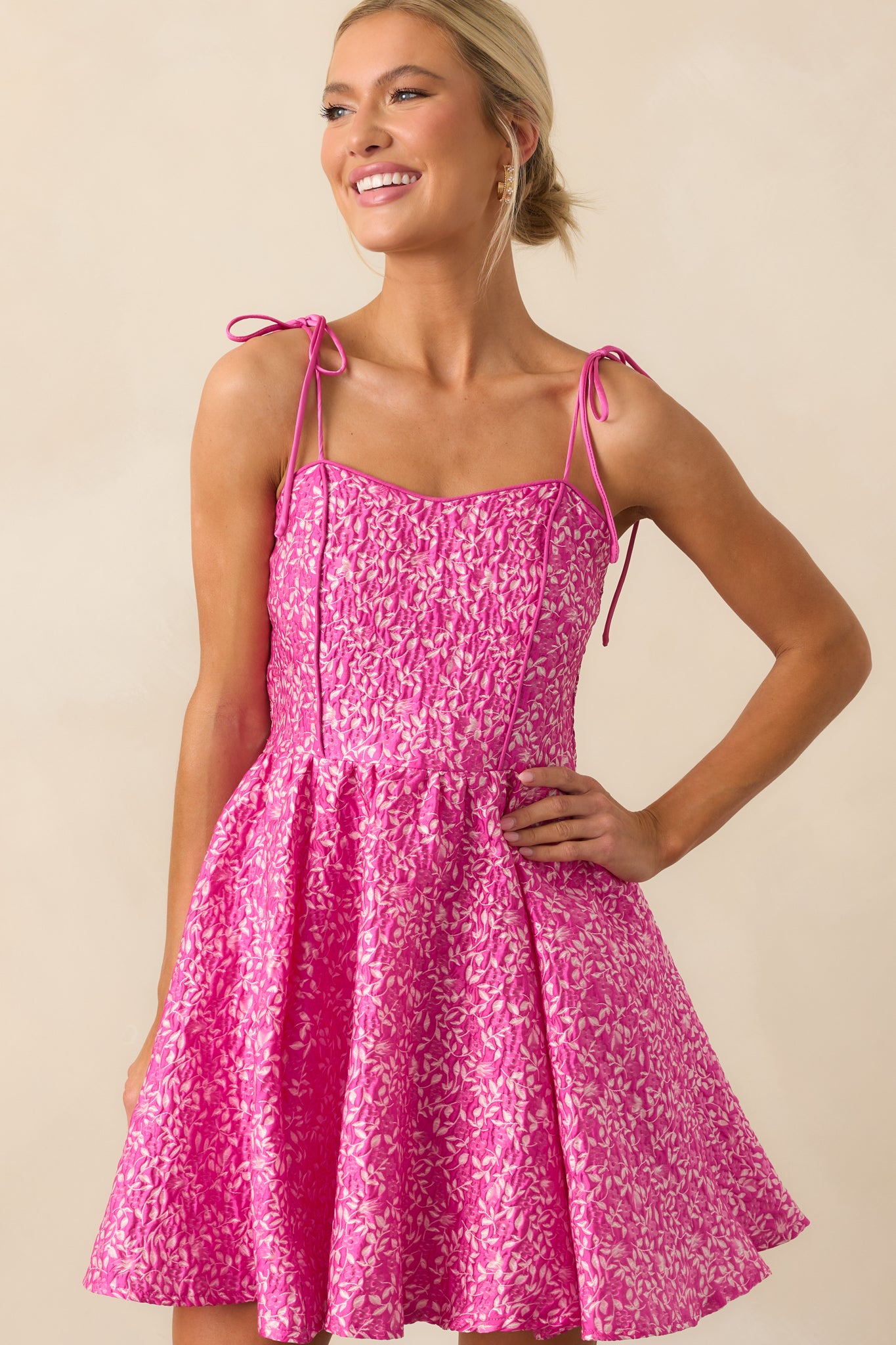 Upper section of the mini dress featuring self-tie bow straps and a softly shaped sweetheart neckline.