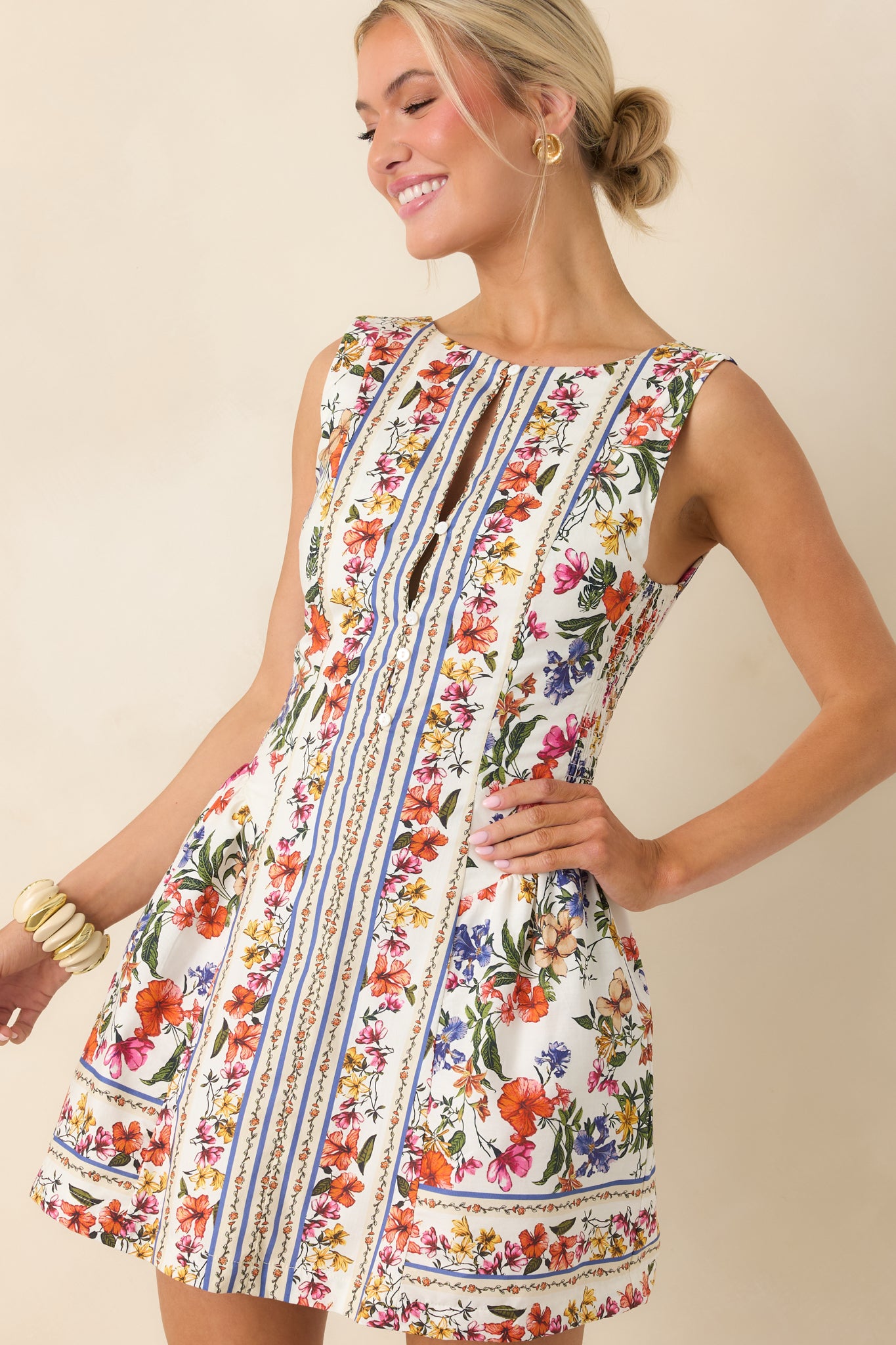 Mini dress close-up showing sleeveless cut and tailored neckline shaping.
