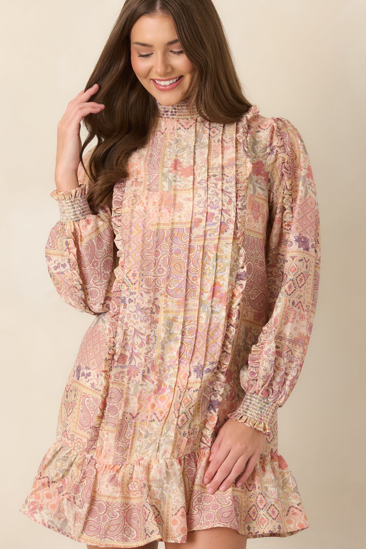 Mini dress showcasing a smocked neckline and coordinating balloon sleeves.