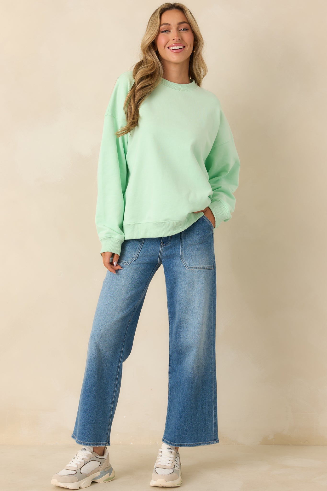 Mint green crewneck sweatshirt with even knit texture and classic ribbed trim.