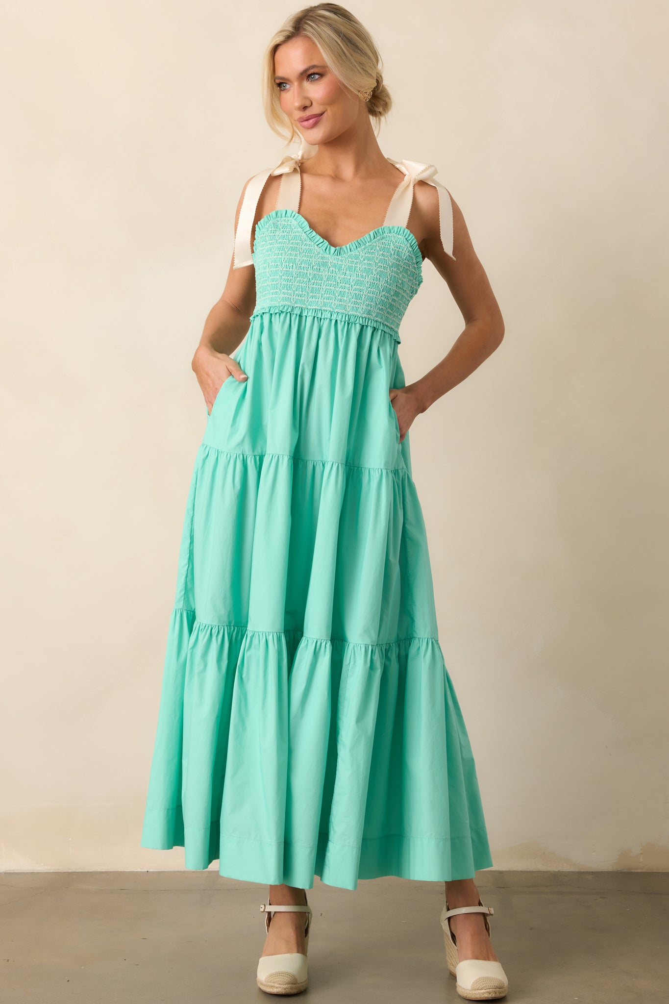 A mint green midi dress with functional pockets, blending practicality with an effortlessly feminine silhouette.