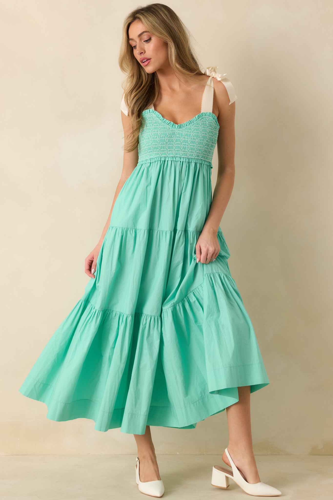 Mint green smocked midi dress showcasing sweetheart neckline, ivory tie straps, and relaxed A-line silhouette.