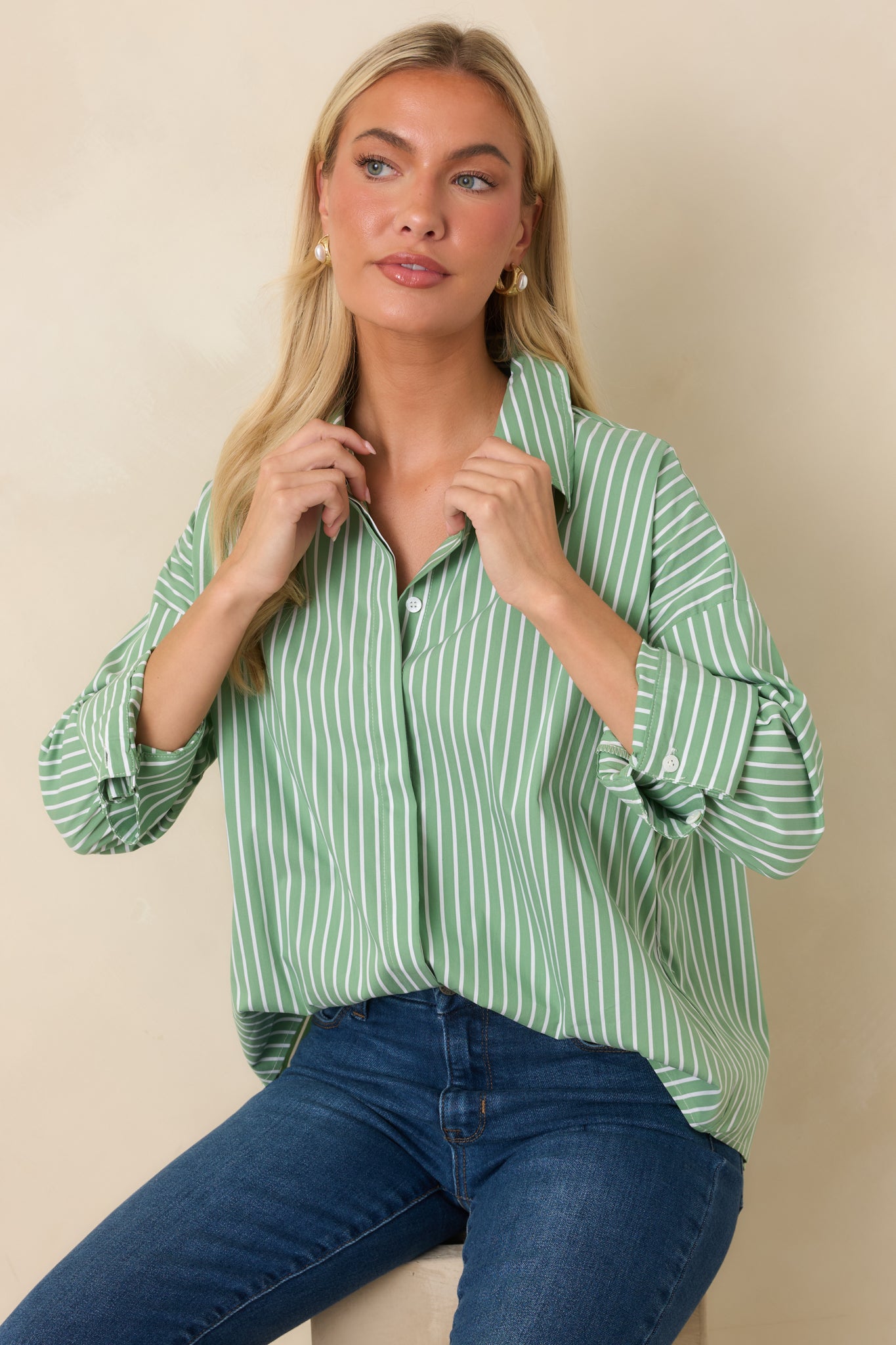 Front detail of the mint striped button-down showcasing the oversized fit, crisp stripes, and clean button-front design.