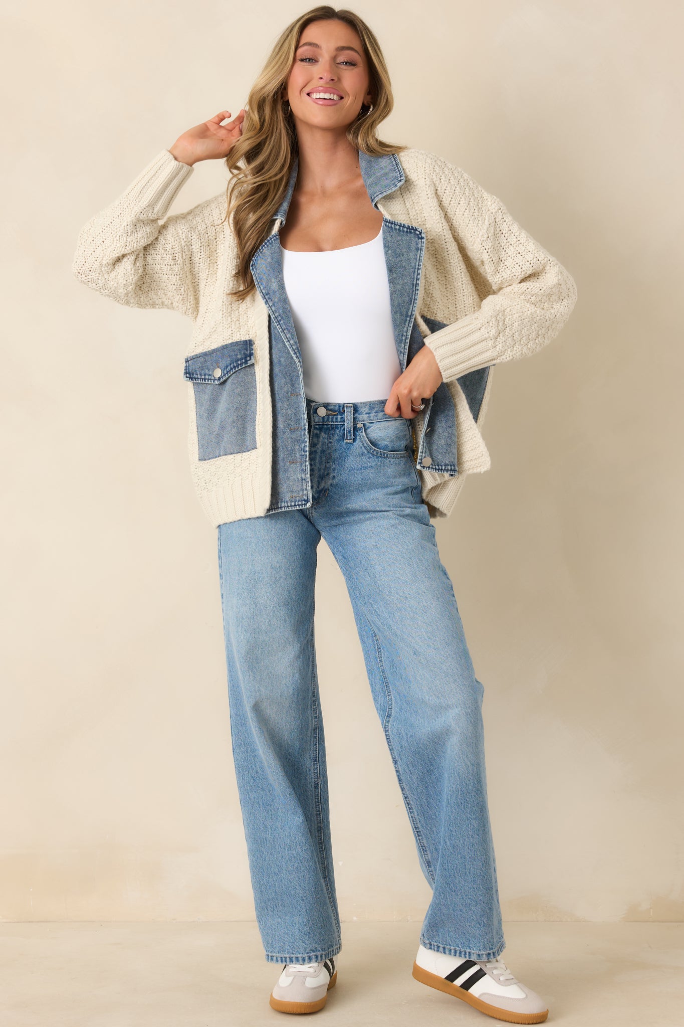Mixed-media jacket featuring a chunky ivory knit body paired with structured denim detailing.