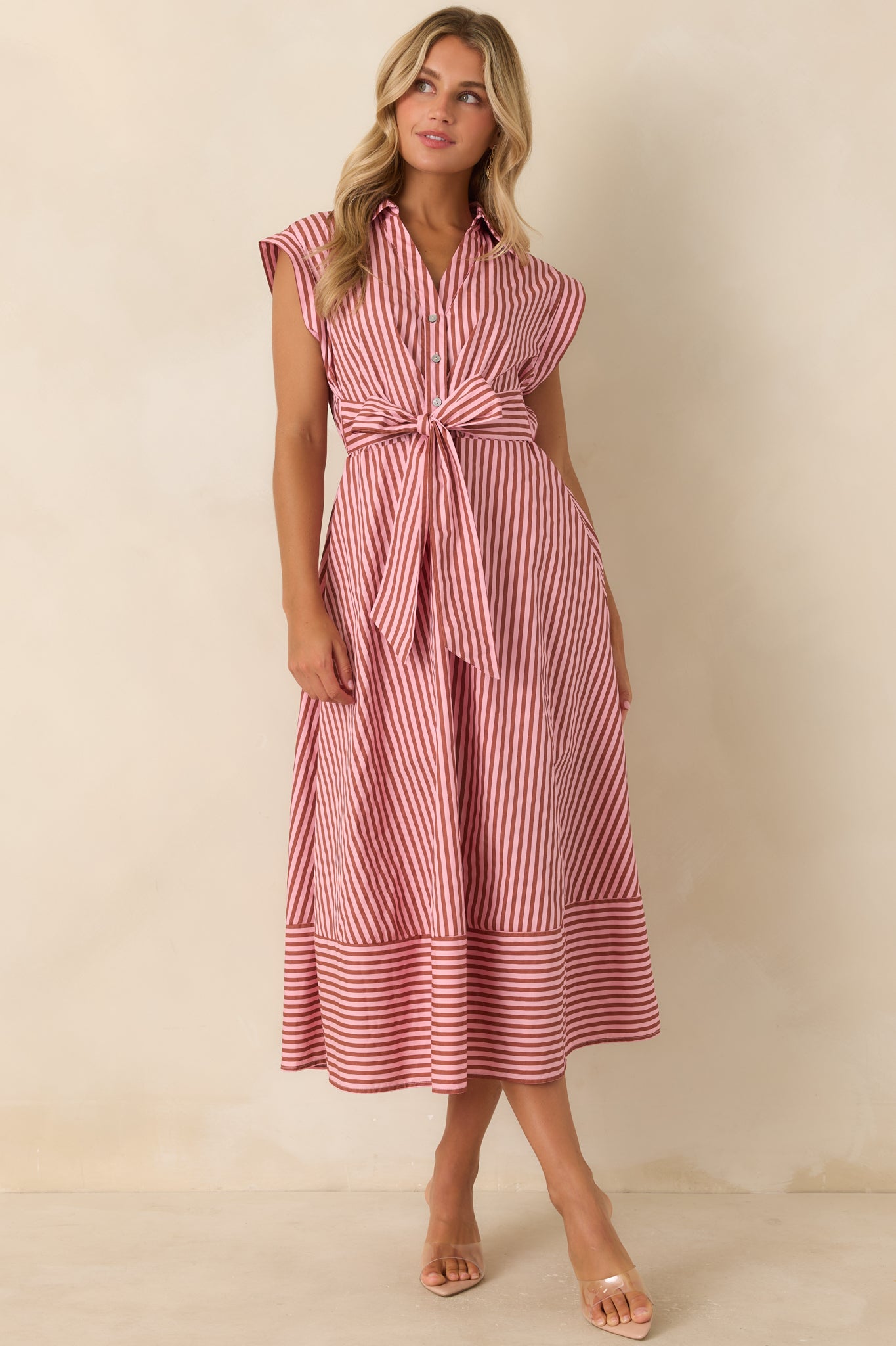 Mixed stripe midi dress featuring a structured collar, partial button front, oversized waist bow, and relaxed polished fit.