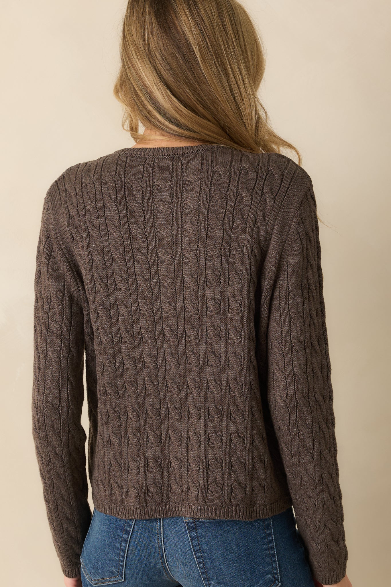 Rear view of the mocha brown cable knit cardigan with ribbed trim and long sleeves.