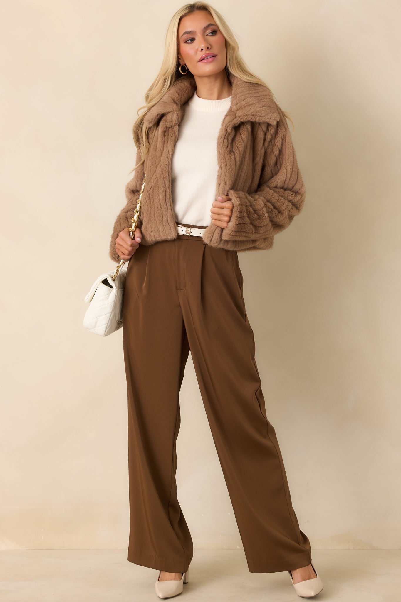 Textured mocha brown faux fur jacket highlighting the wide collar, long sleeves, and structured cropped fit with smooth lining beneath.