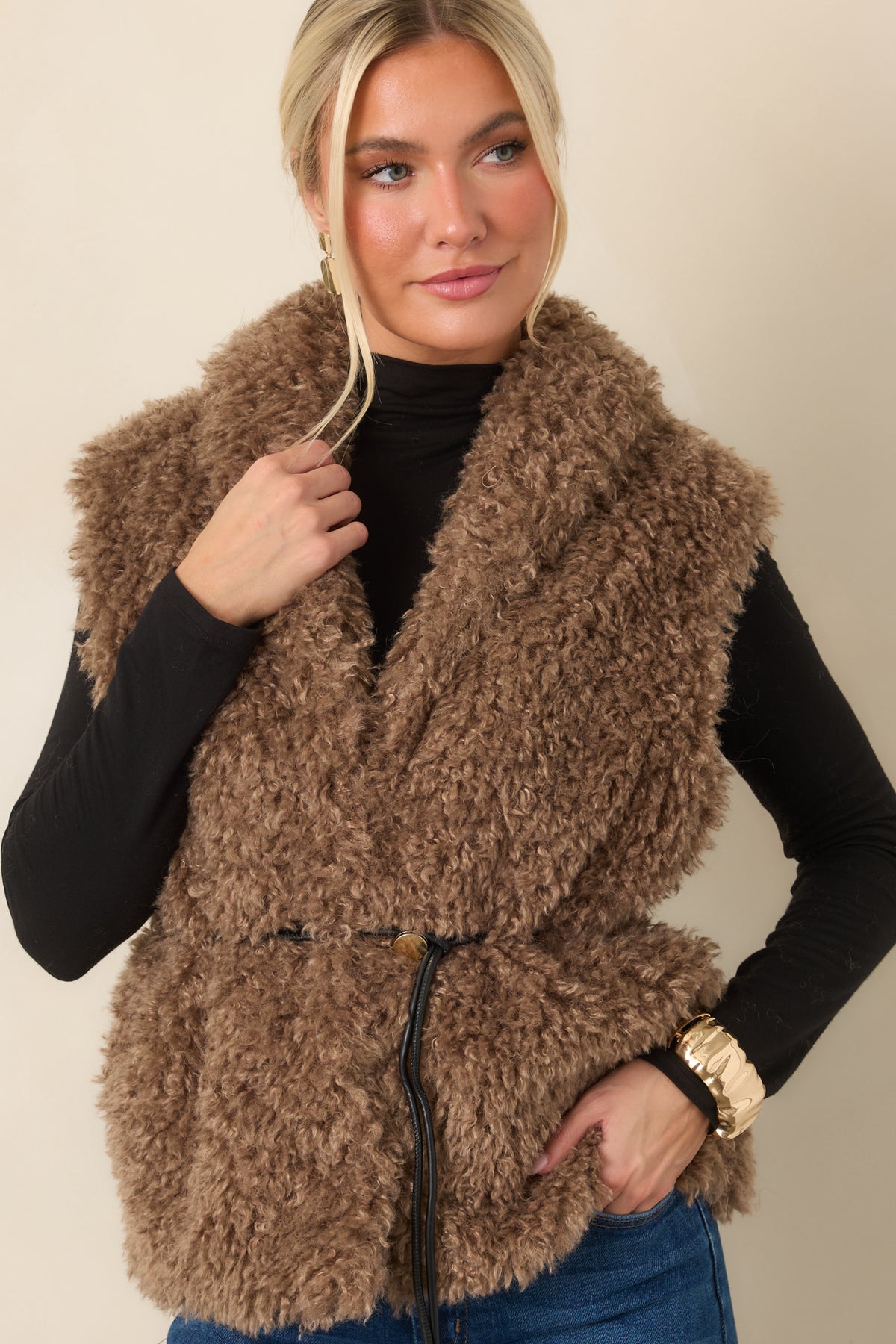 Close view of the warm mocha curly faux fur texture and oversized shawl collar.
