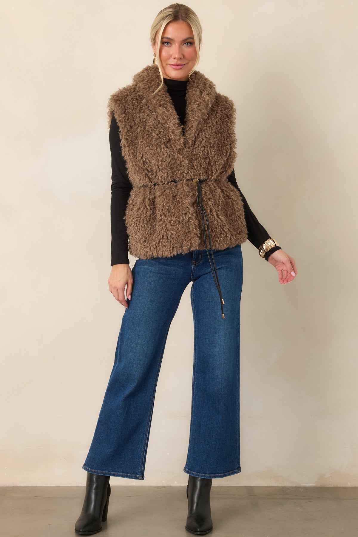Warm mocha curly faux fur vest with an oversized shawl collar, hip-length silhouette, and functional pockets.
