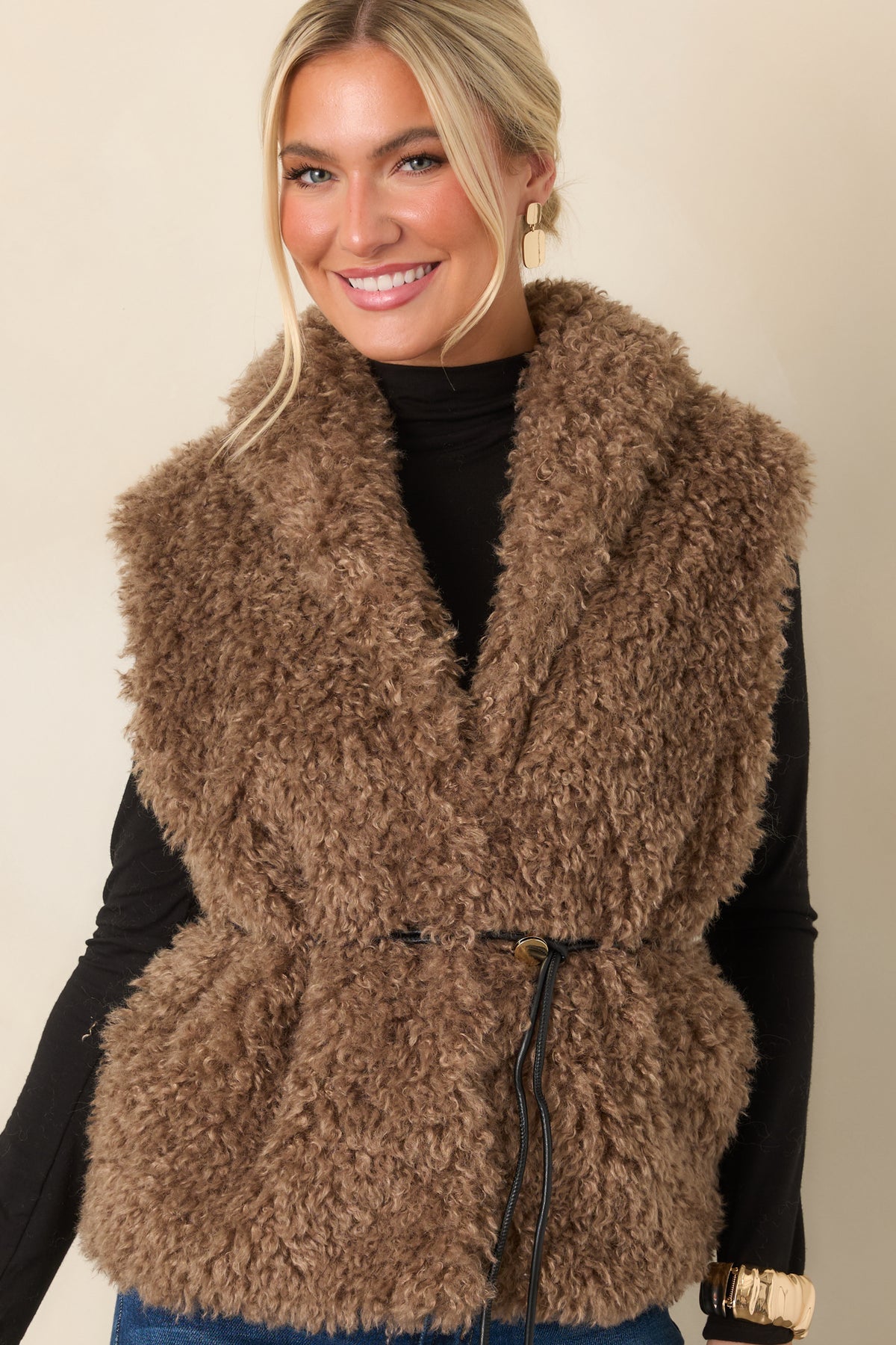 Mocha faux fur vest highlighting the removable faux leather drawcord belt and softly gathered waist.
