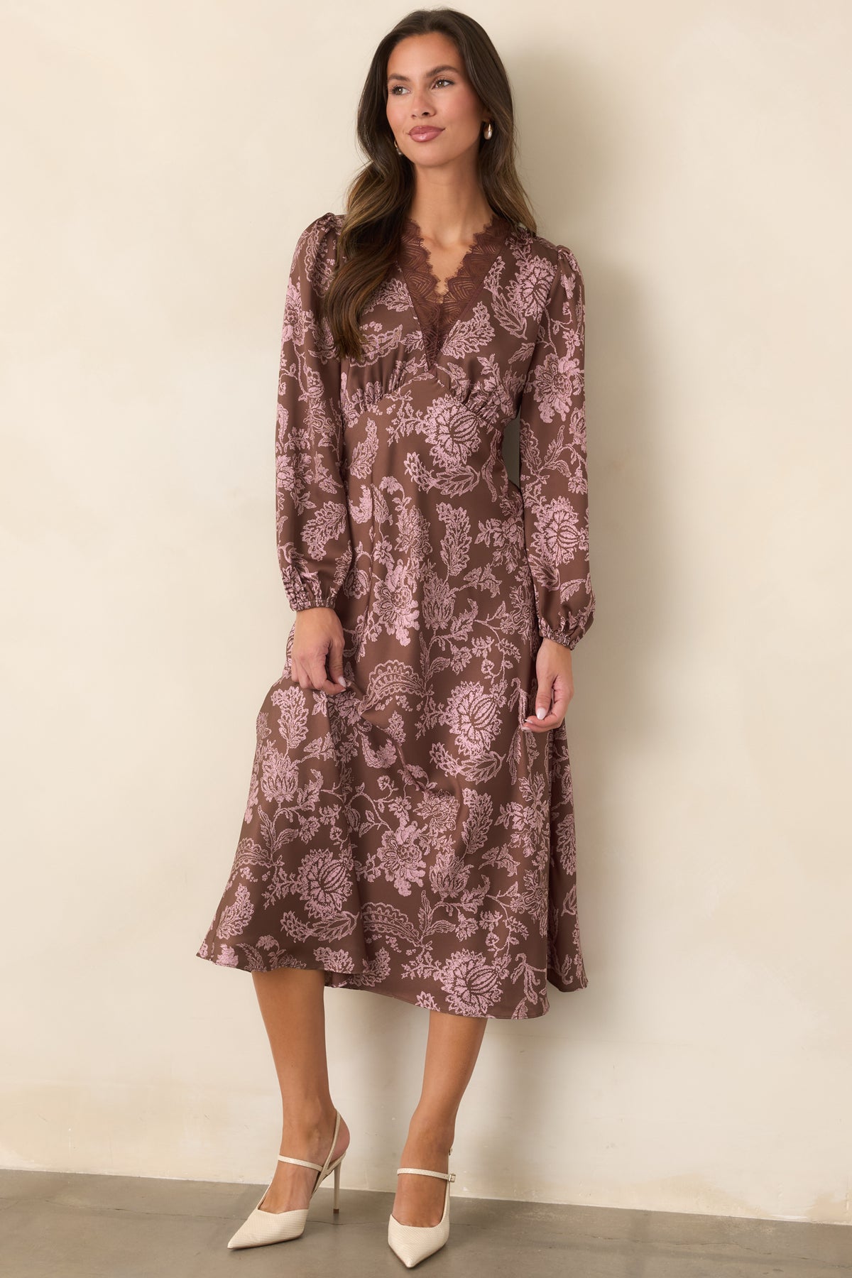Mocha floral dress featuring long sleeves with elasticized cuffs and a flowing midi silhouette.