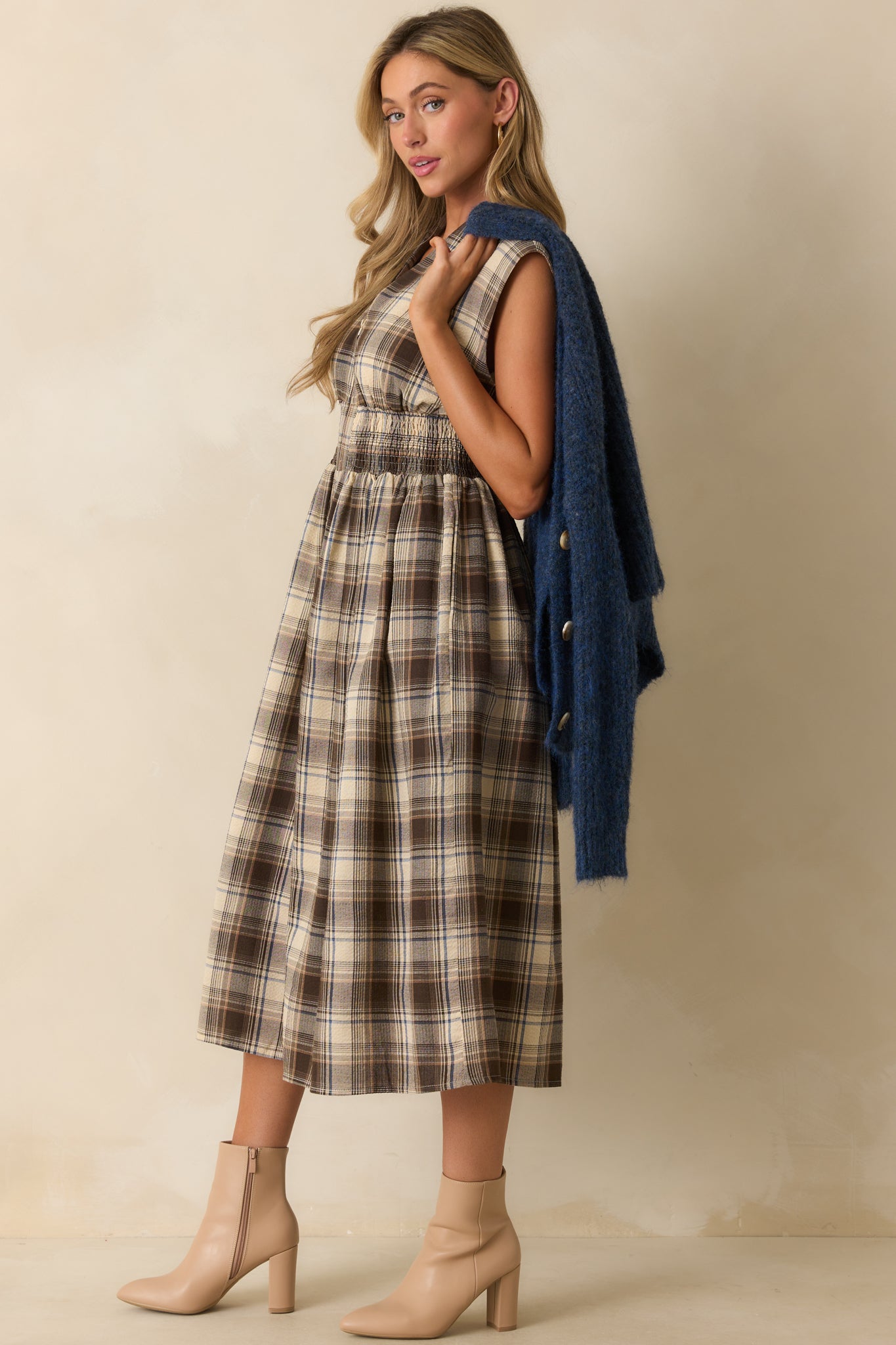 Mocha plaid dress highlighting its hip pockets and relaxed yet polished silhouette.