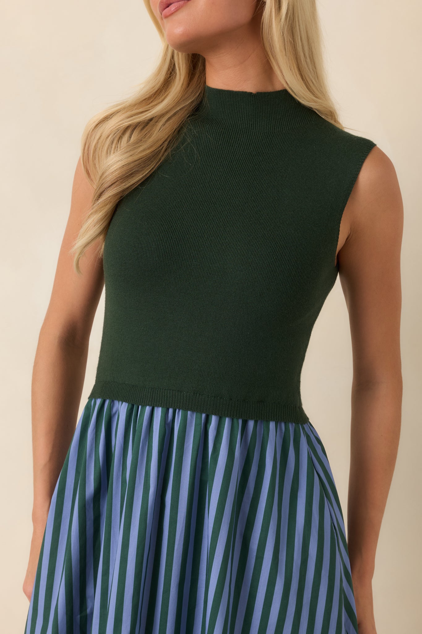Close-up of the dress highlighting the refined mock neckline, knit texture, and light blue striped detailing.