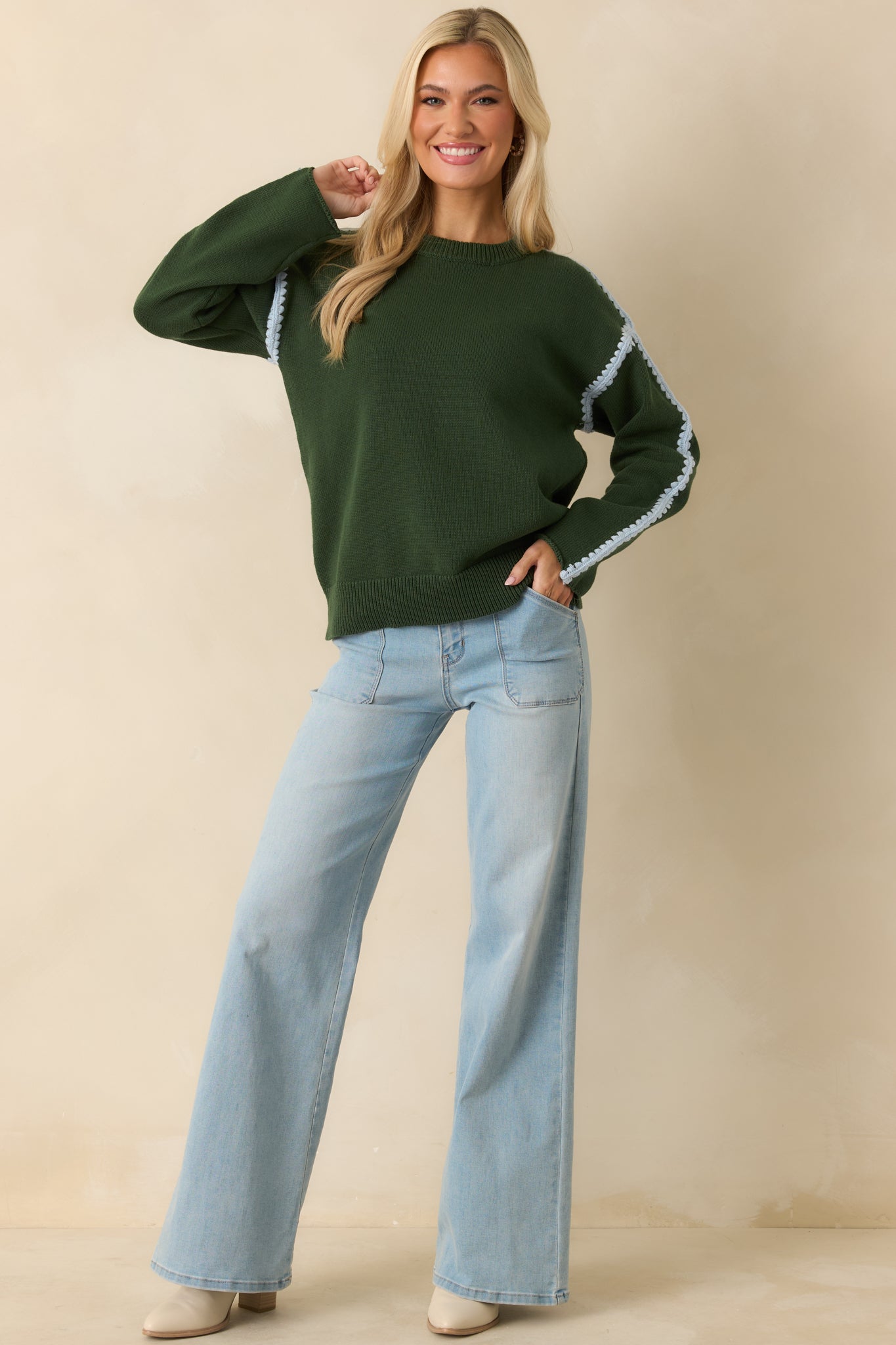 Cotton knit sweater in moss green with subtle structure and clean ribbed edges.