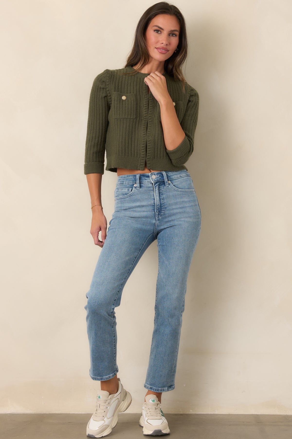 Moss green cropped cardigan with vertical ribbing, gathered shoulders, three-quarter sleeves, and ribbed cuffs.