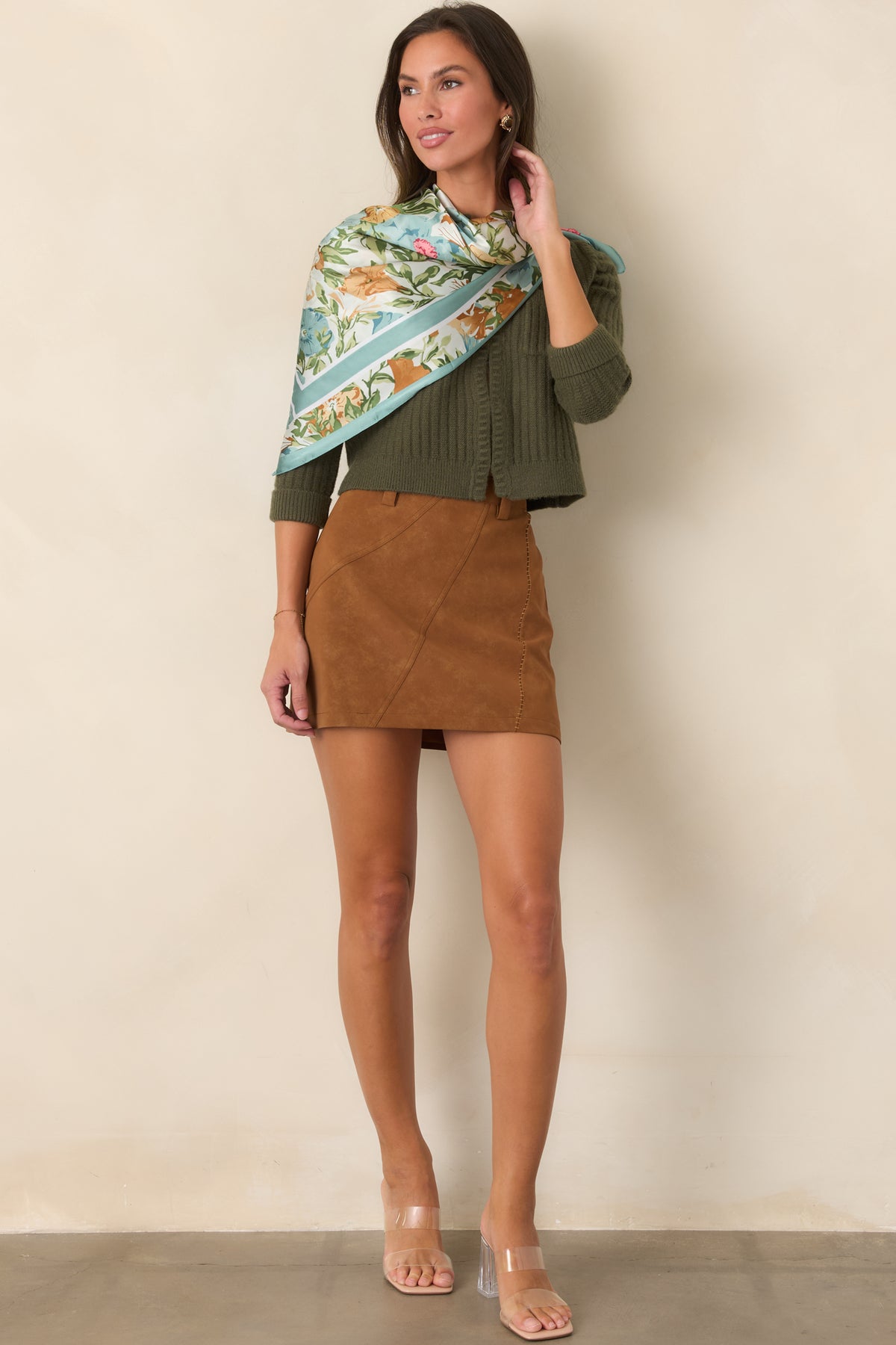 Moss green knit cardigan showcasing vertical ribbing, chest pockets, and a clean front opening.