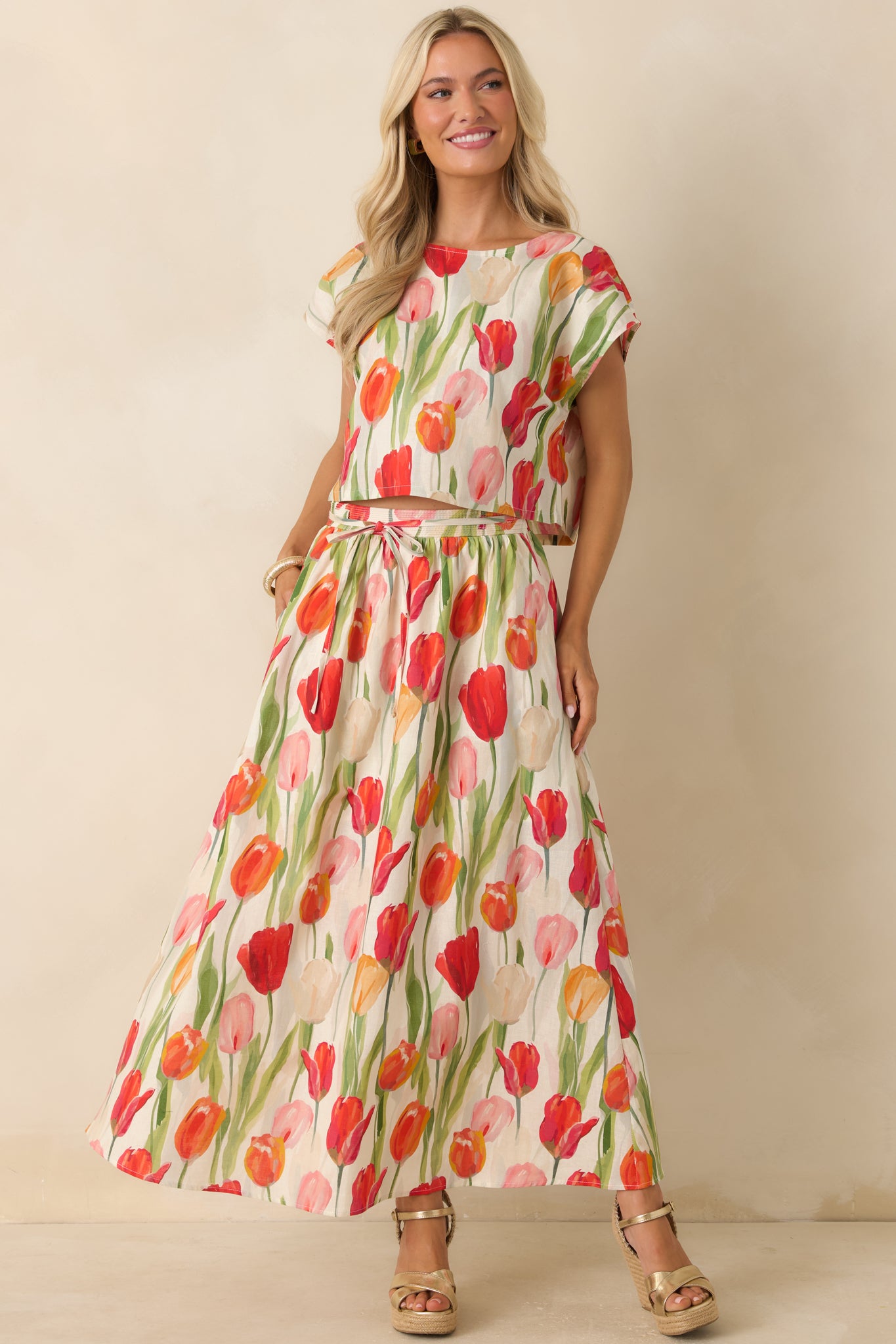 Multi-colored linen blend midi skirt featuring a vibrant tulip print, hidden side pockets, and soft movement through the skirt.