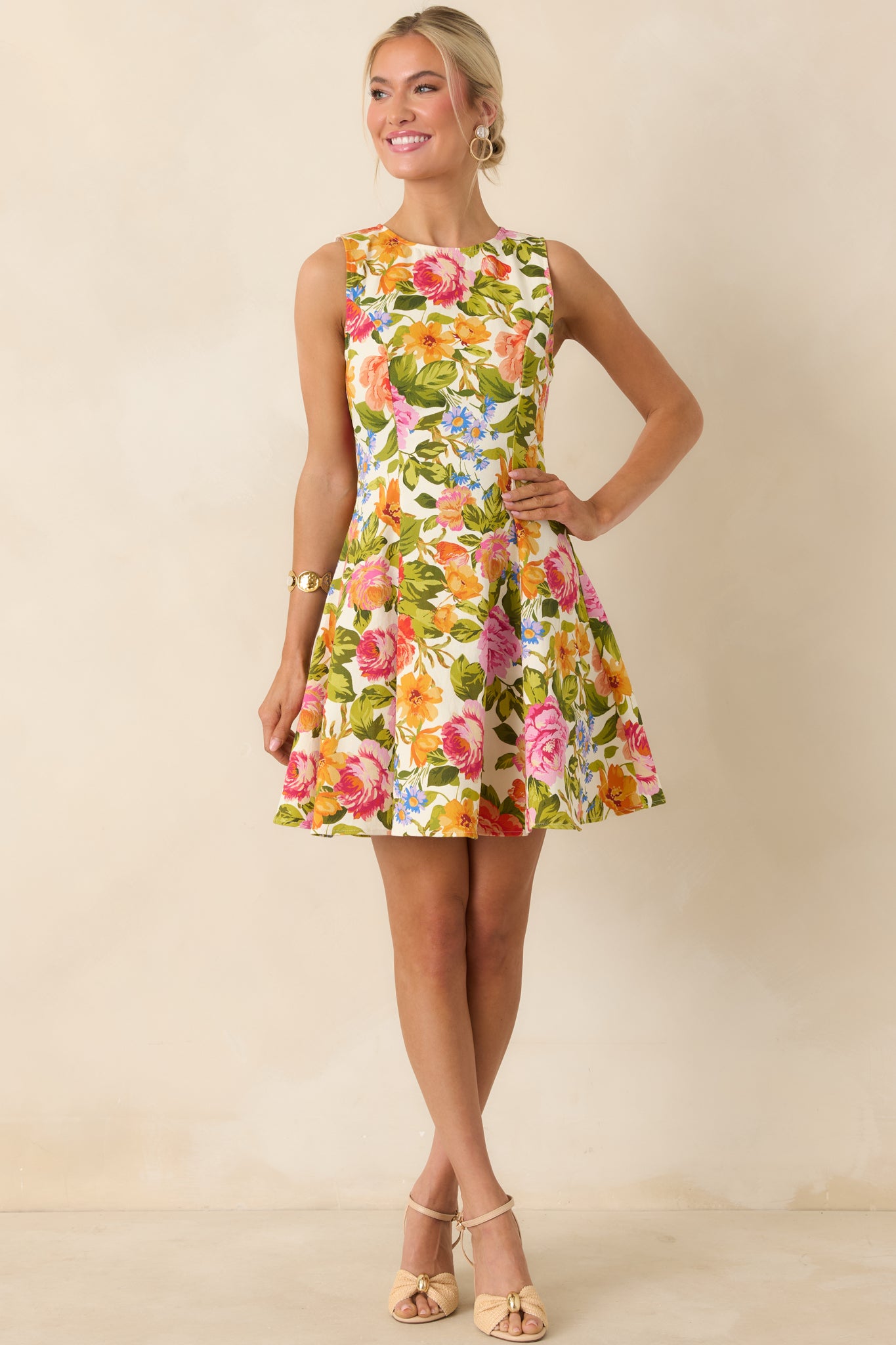 Multi-floral ivory dress with a high neckline and tailored fit, leading into a playful flared hem.