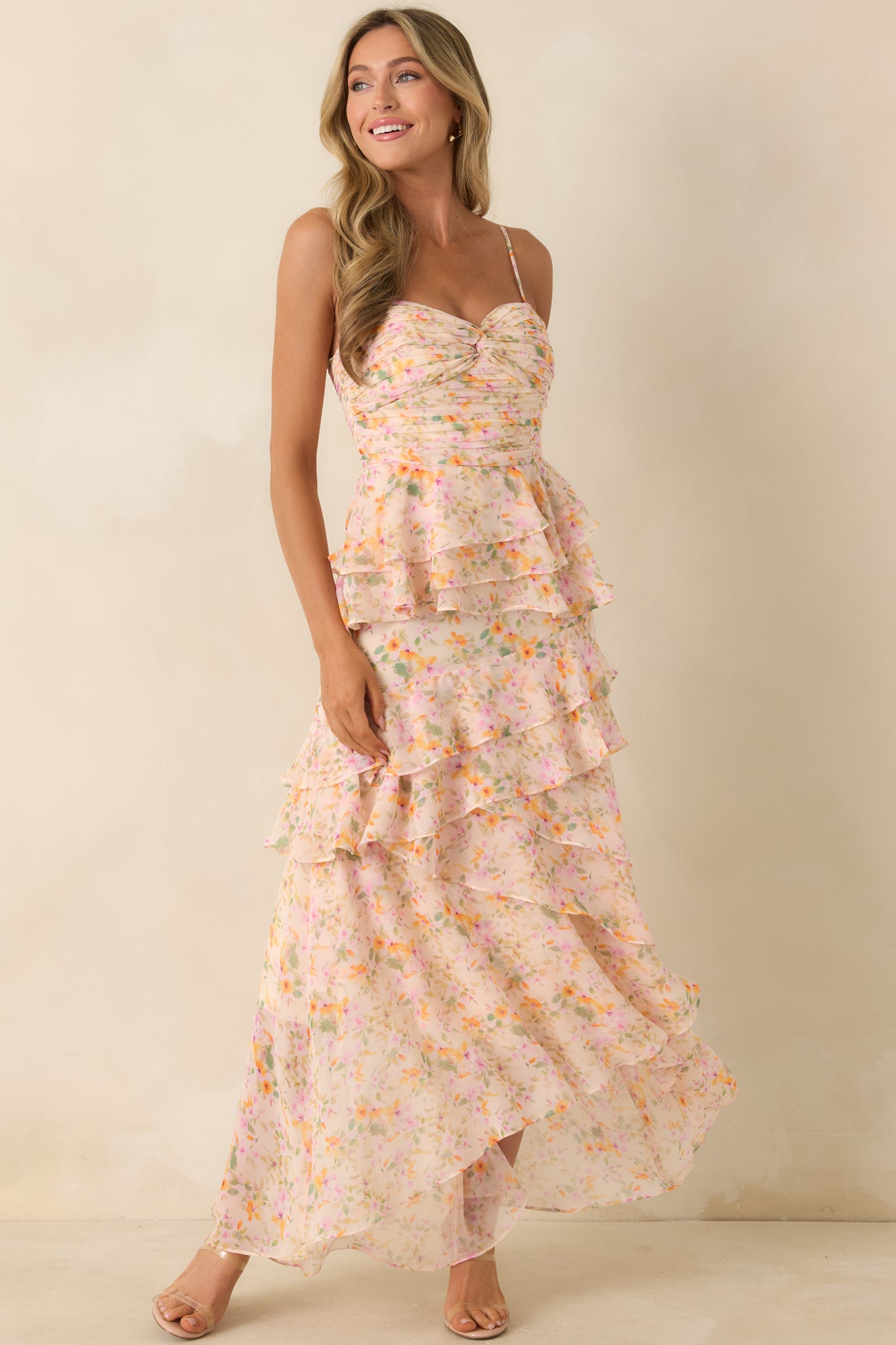 Multi floral maxi dress featuring a twist-front neckline and cascading ruffle layers in a full-length design.