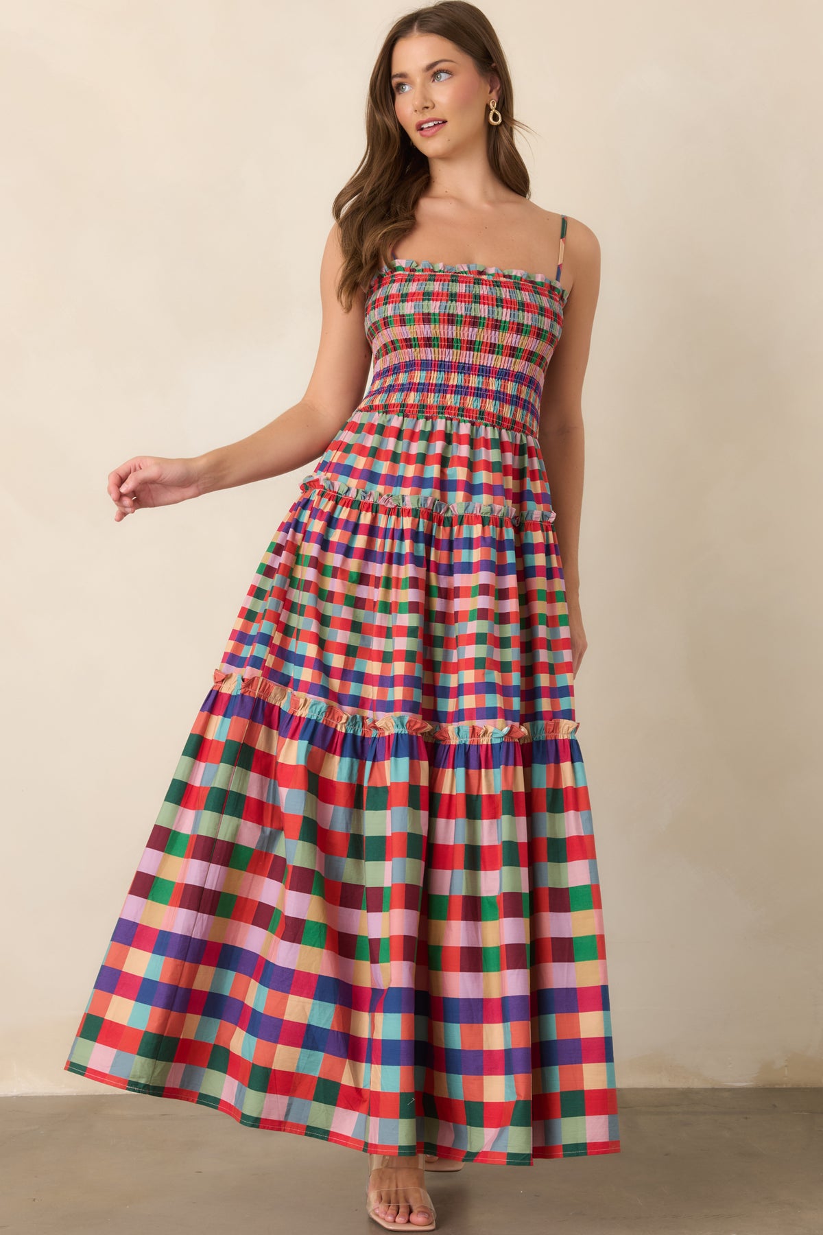 Multi plaid maxi dress showcasing ruffled seam accents across its flowing tiered skirt.
