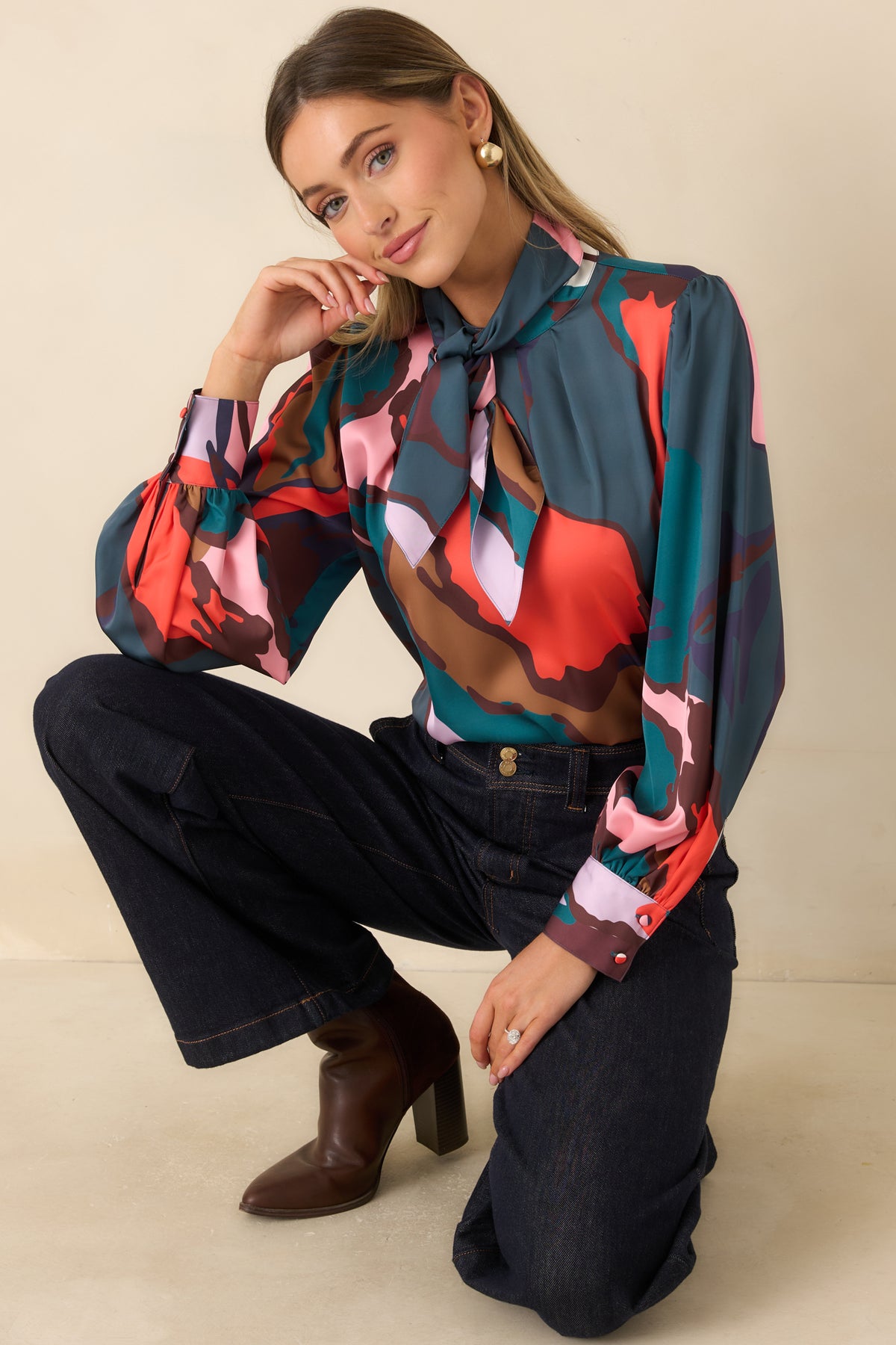 Multicolor abstract print blouse with a round neckline, long sleeves, and a removable neck tie.