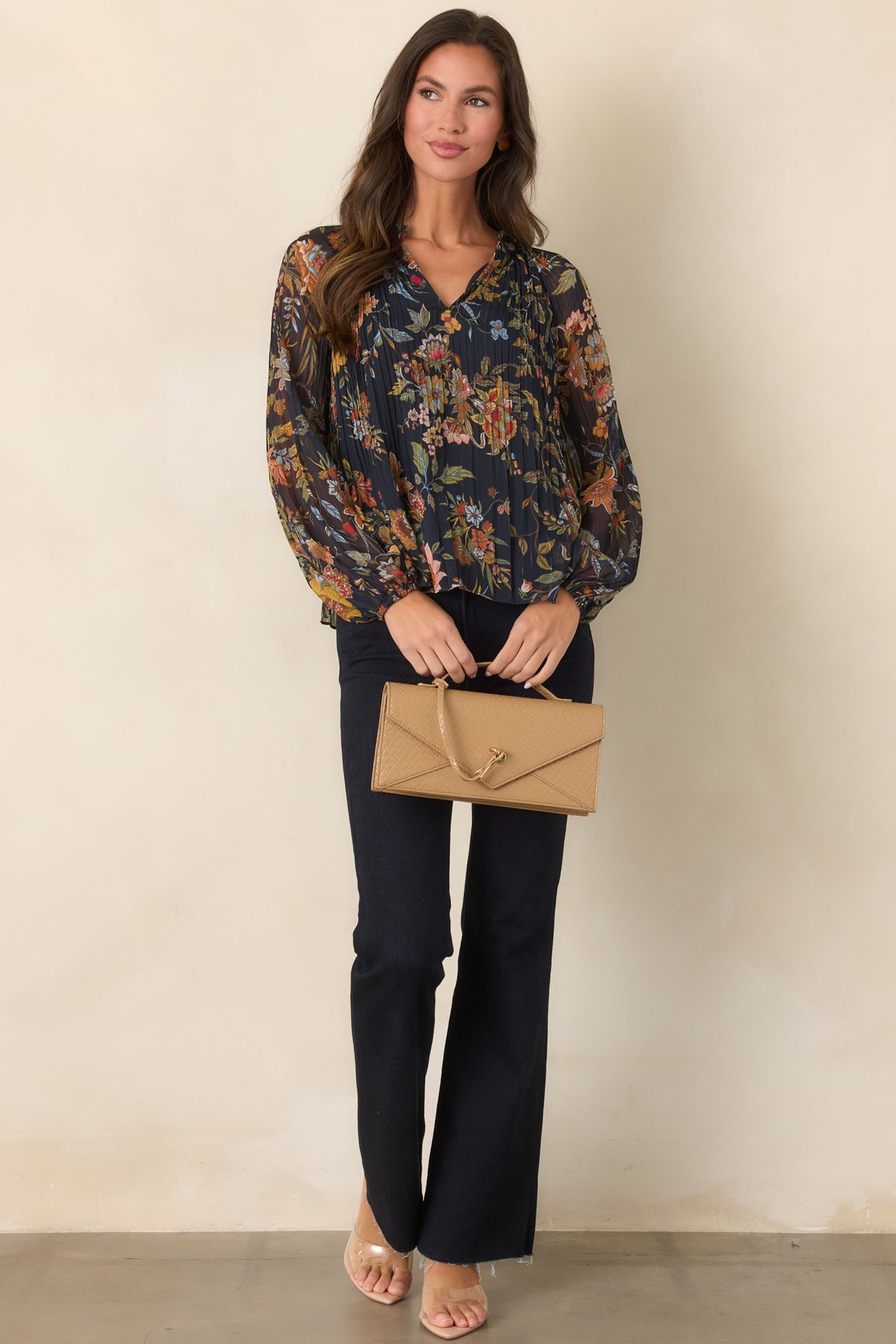 Multicolor botanical top featuring fine pleating, softly gathered ruffle detailing, and long sheer sleeves with elasticized cuffs.
