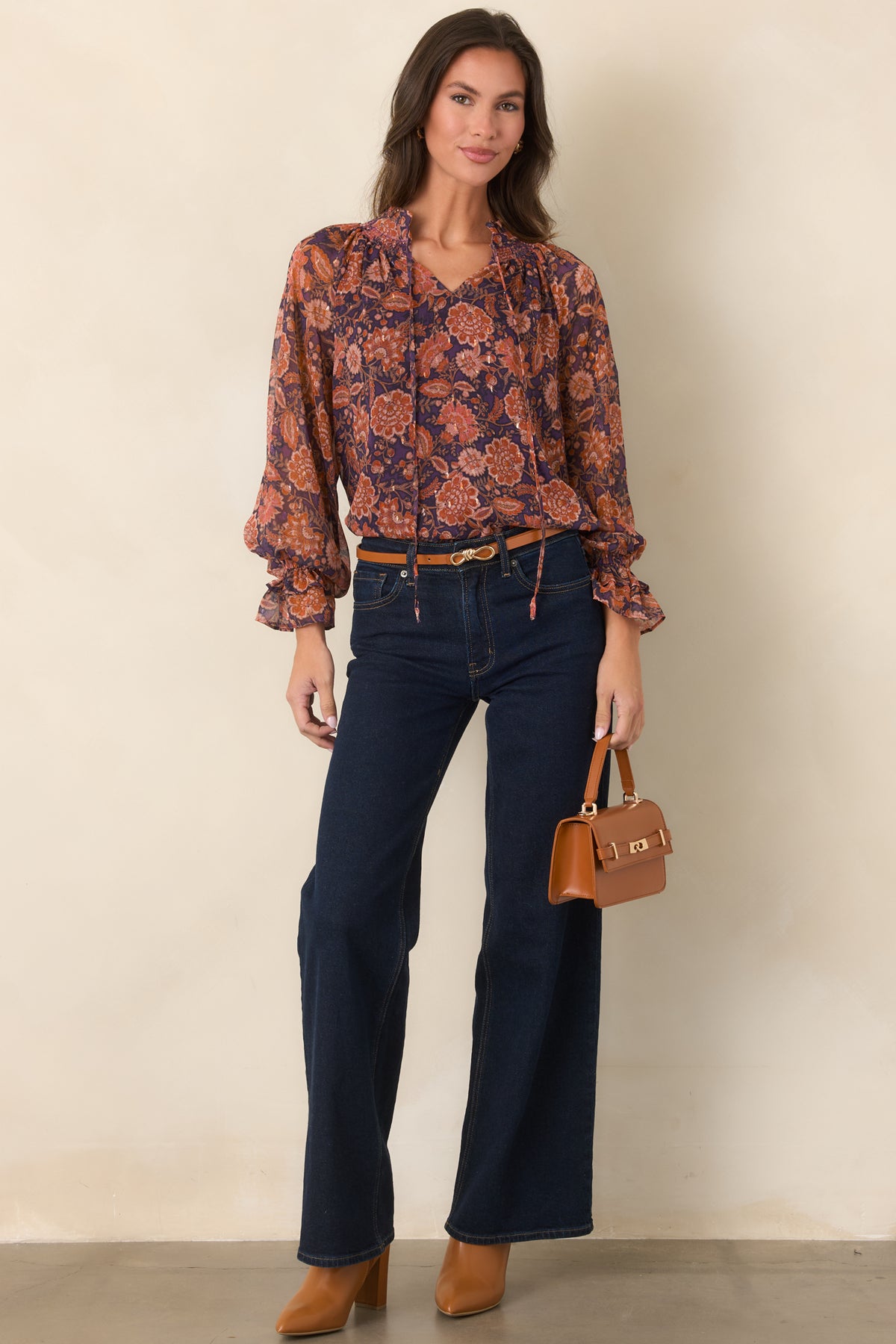 Multicolor floral top with a romantic split neckline, flowing sheer sleeves, and softly ruffled edges.