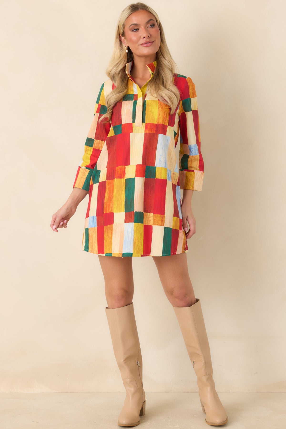 Multicolor geometric mini dress featuring a relaxed shift silhouette, wide sleeve cuffs, and red, yellow, green, and blue print.