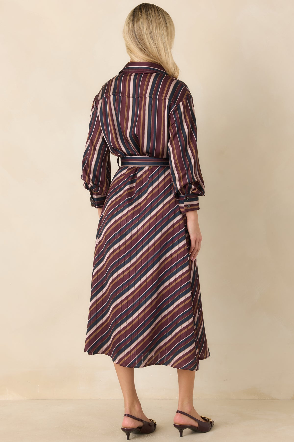 Multicolor satin dress showcasing the vertical striped bodice, defined waist, and flowing skirt from the rear.