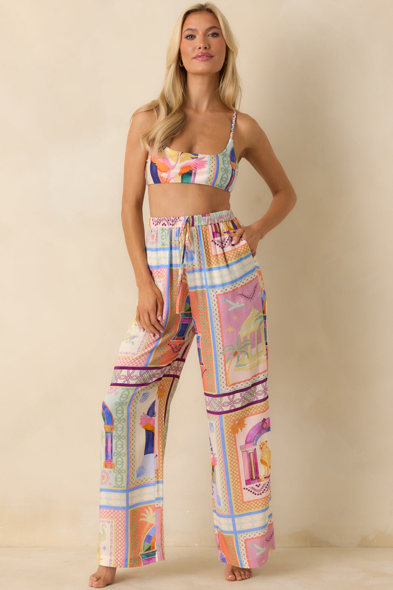 Multi-color tropical pants showing a breezy woven fabric with a bold tile-inspired print and relaxed full-length legs.