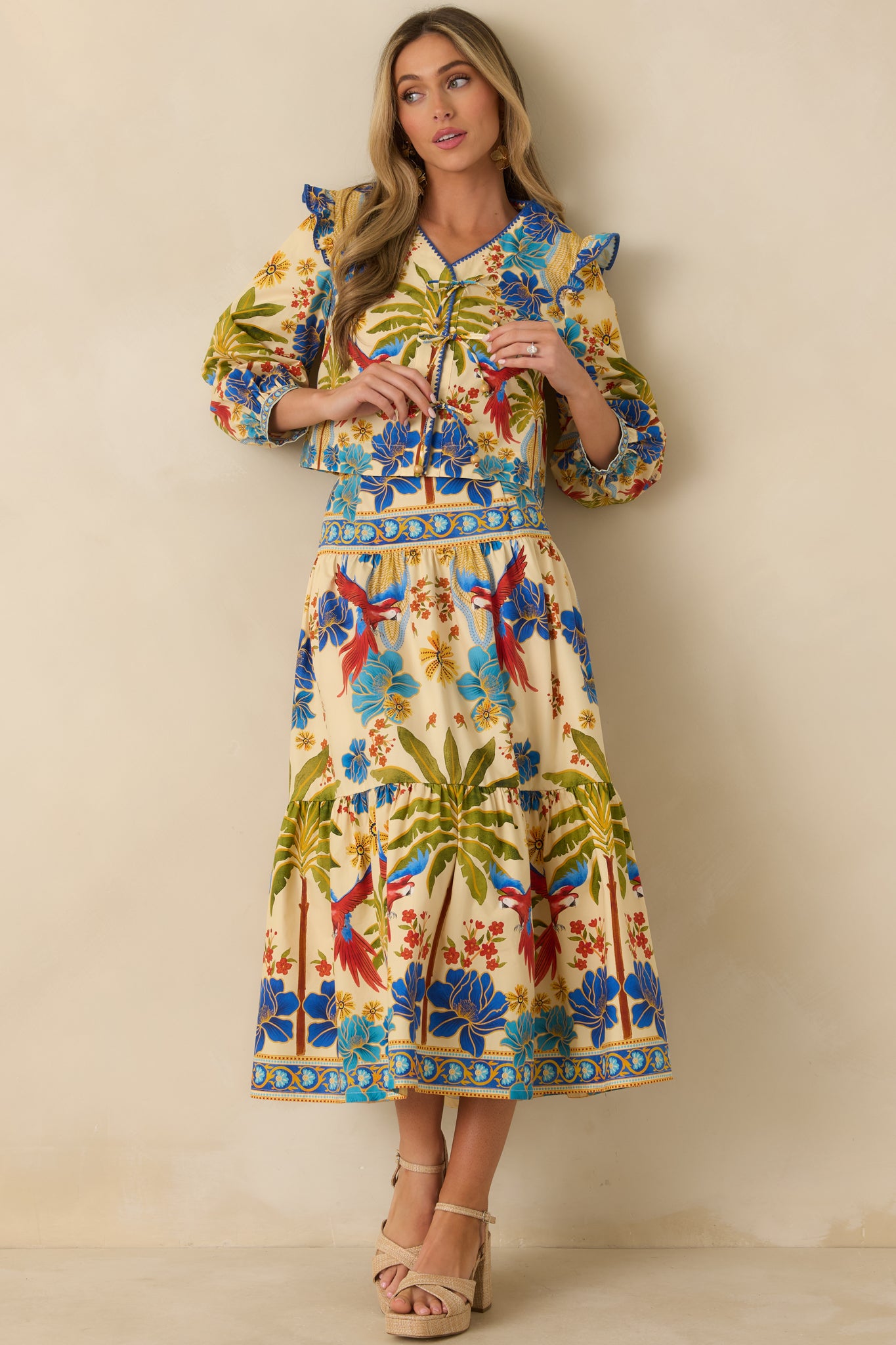 Front view of multicolored top with V-neckline, adjustable tie-front closure, and ruffled shoulders.